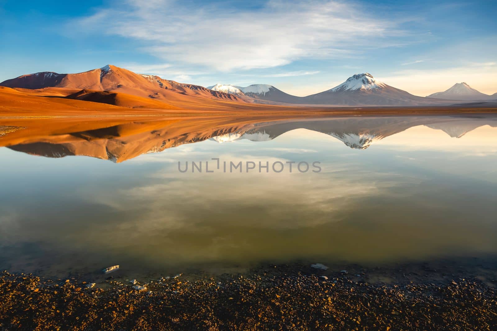 Salt lake Lejia reflection and idyllic volcanic landscape at Sunset, Atacama desert, Chile