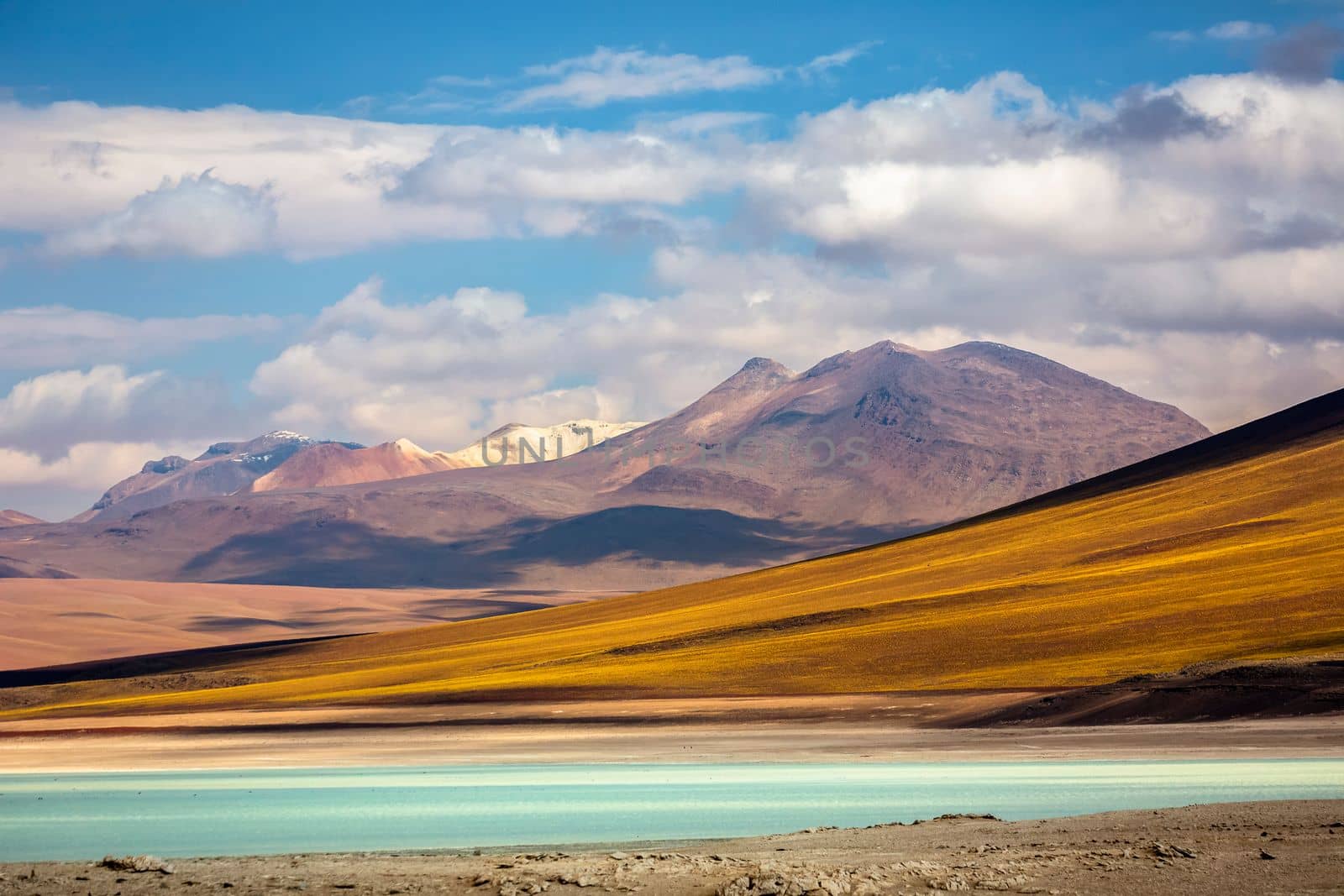Salt lake reflection and idyllic volcanic landscape at Sunset, Atacama desert, Chile border with Bolivia
