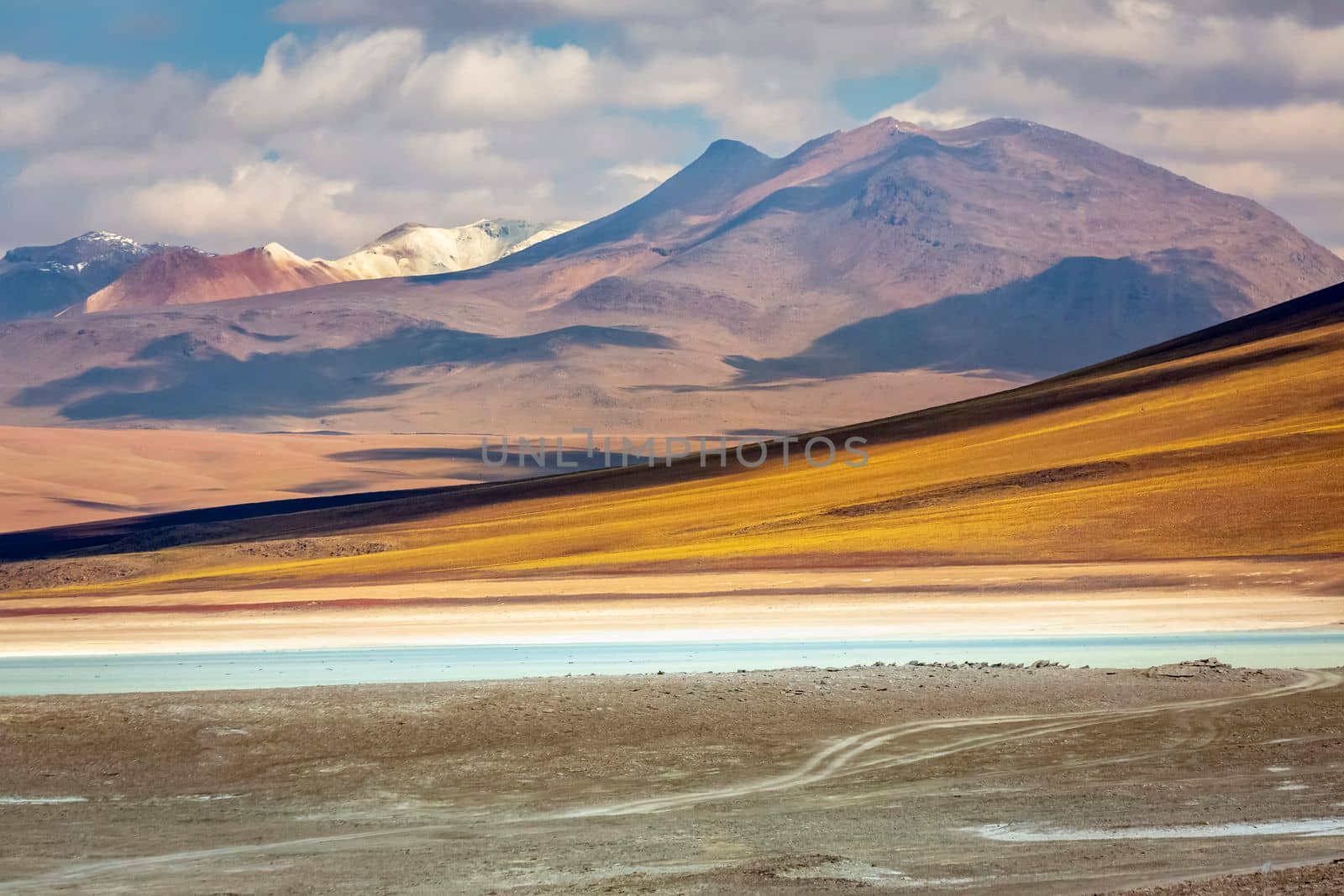 Salt lake reflection and idyllic volcanic landscape at Sunset, Atacama desert, Chile border with Bolivia