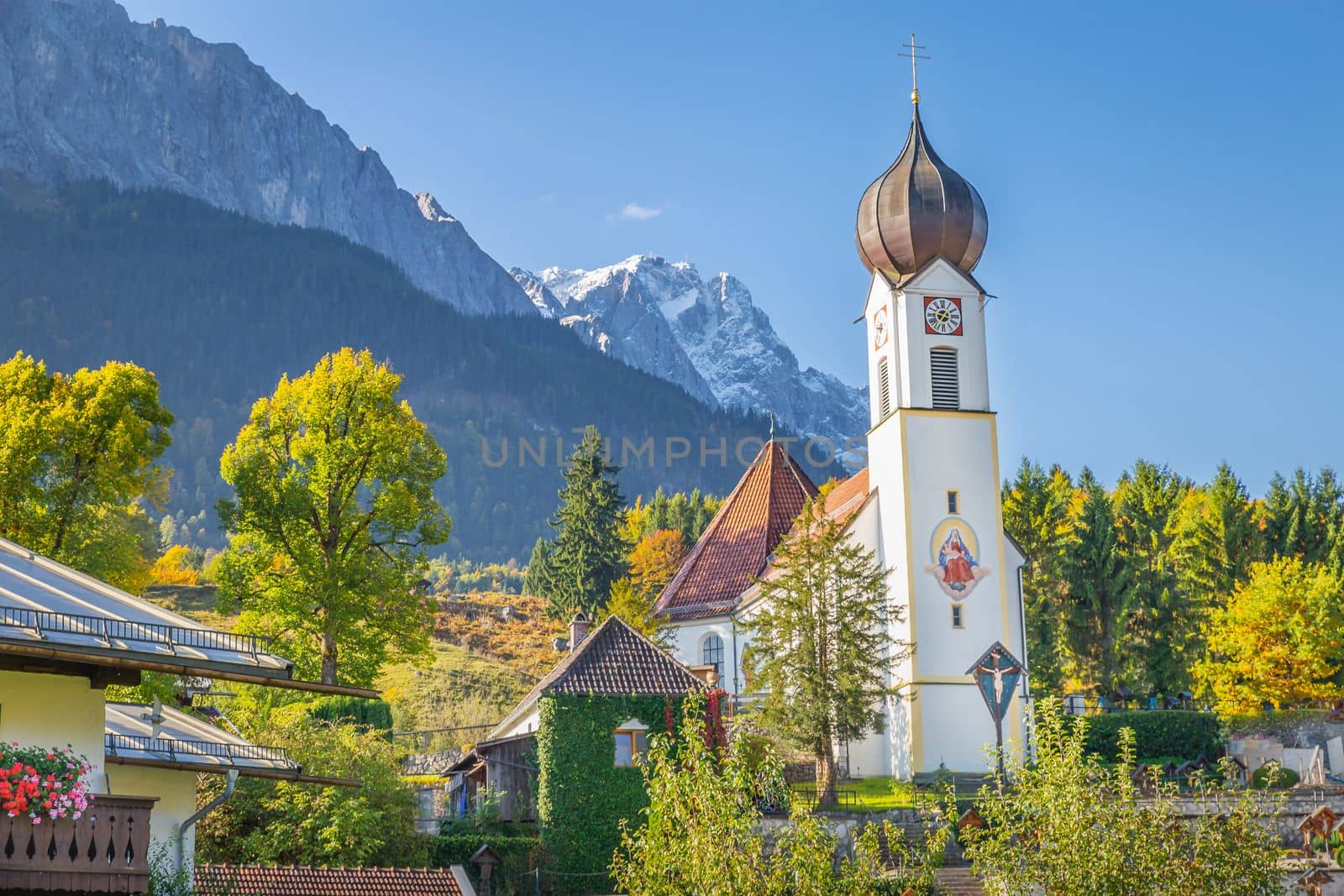 Grainau Church at golden autumn sunrise and Zugspitze massif, Bavarian alps , Germany