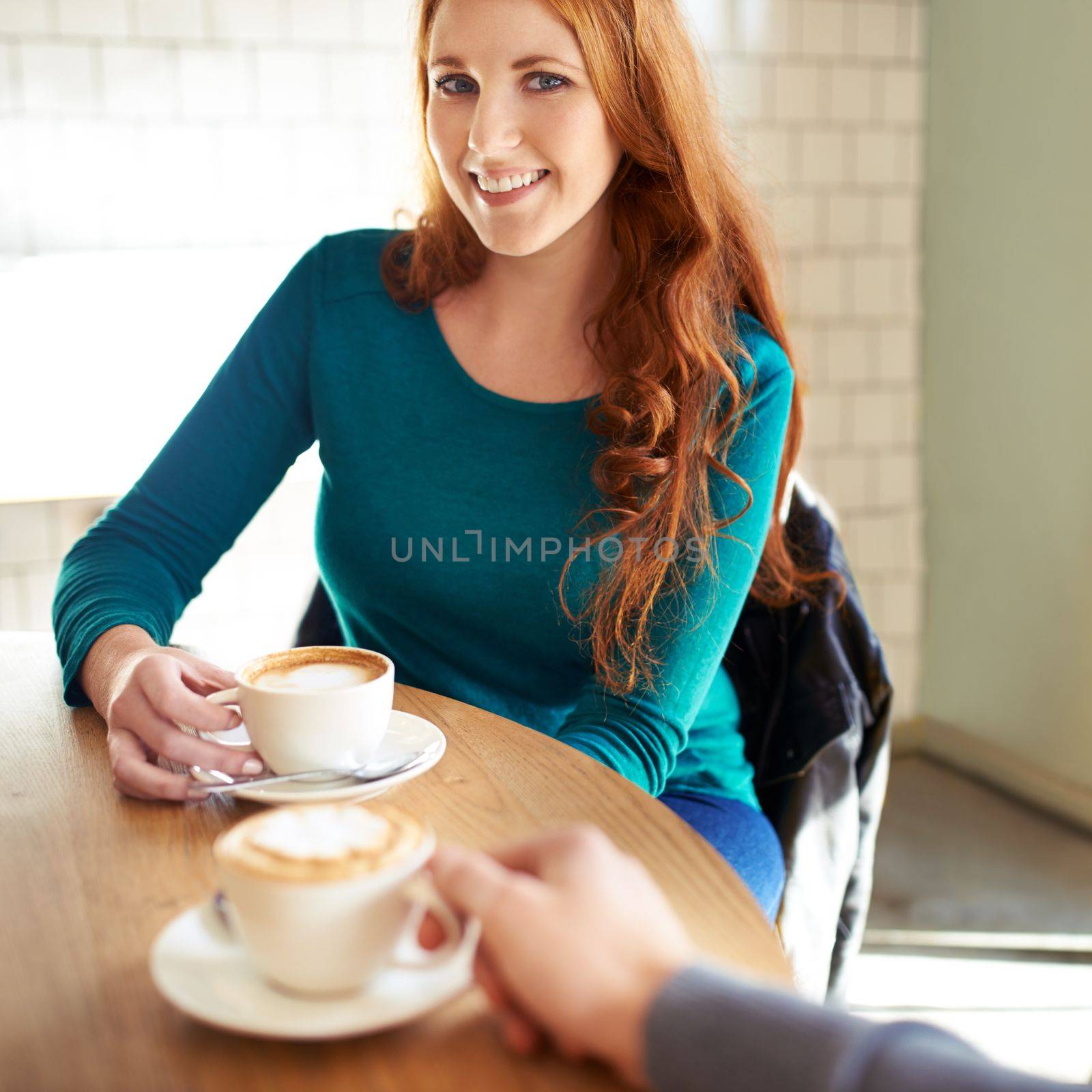 Coffee date with a crush. A cropped shot of a young affectionate couple on a coffee date