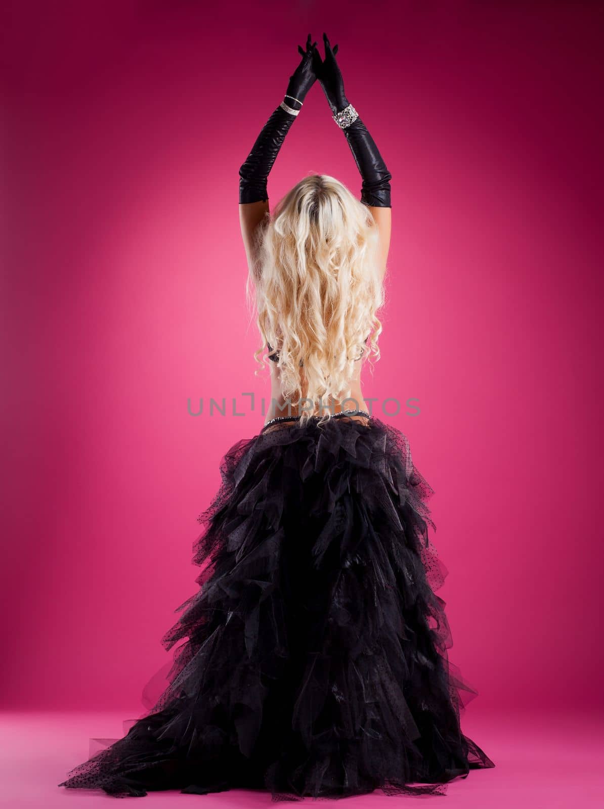 Sexy woman with long blond hairs posing in oriental east costume isolated