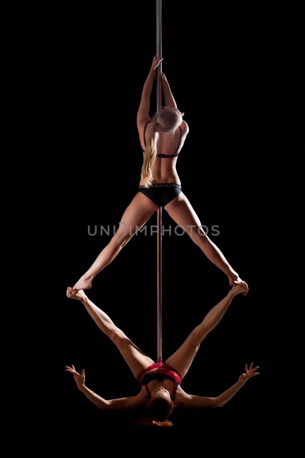 two women show high gymnastic level on pole dance by rivertime