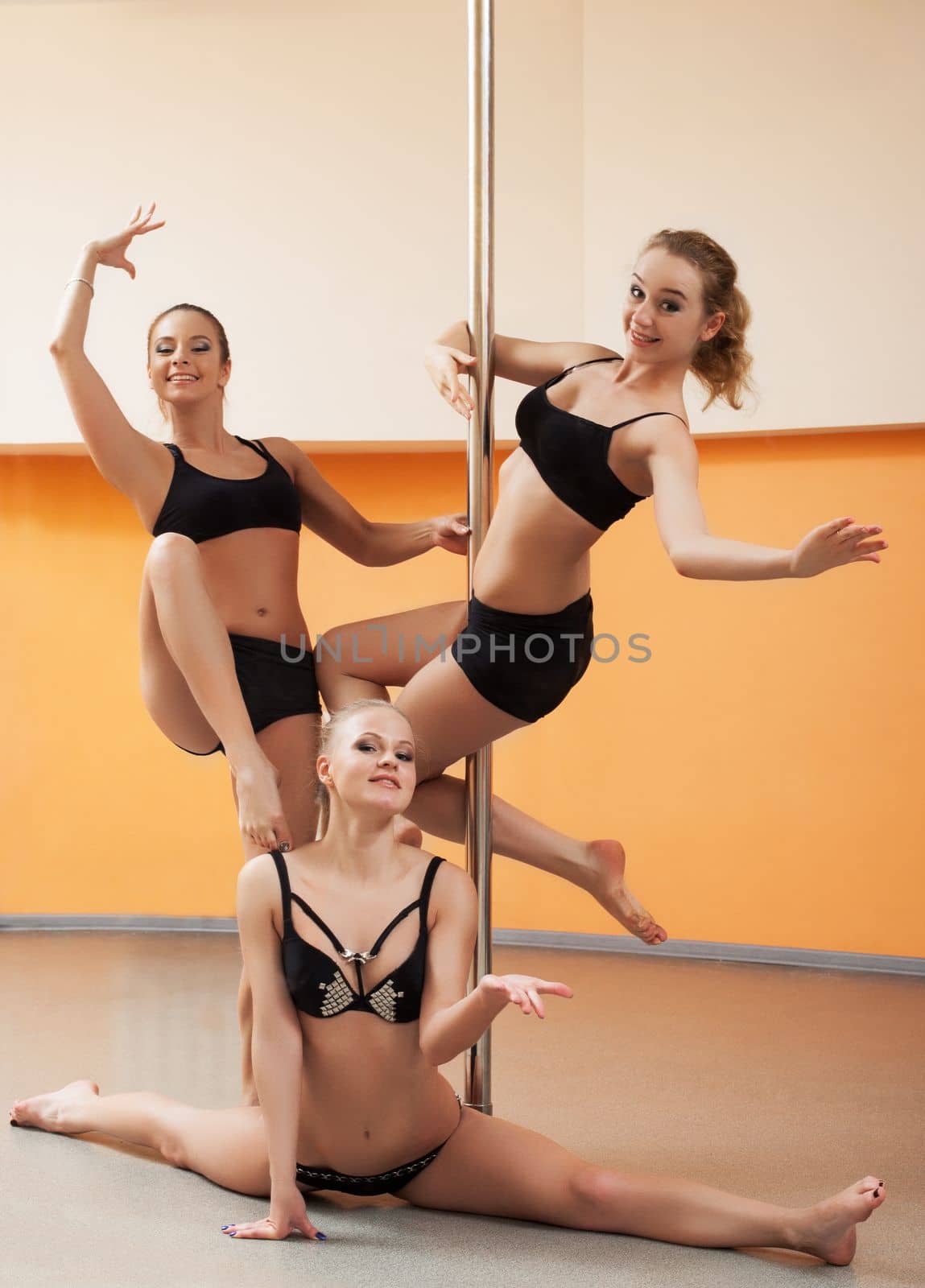 Young women doing gymnastic exercise by rivertime