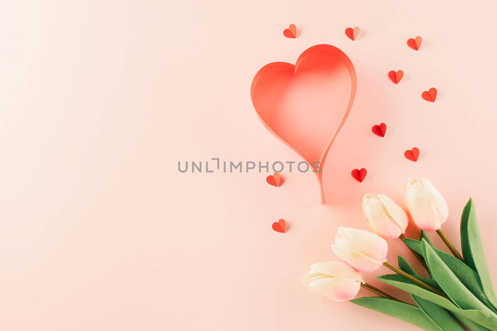 Happy Valentines Day background. Top view flat lay of red paper hearts shape and pink tulips flower on pink background with copy space, Valentine day concept, Banner of holiday