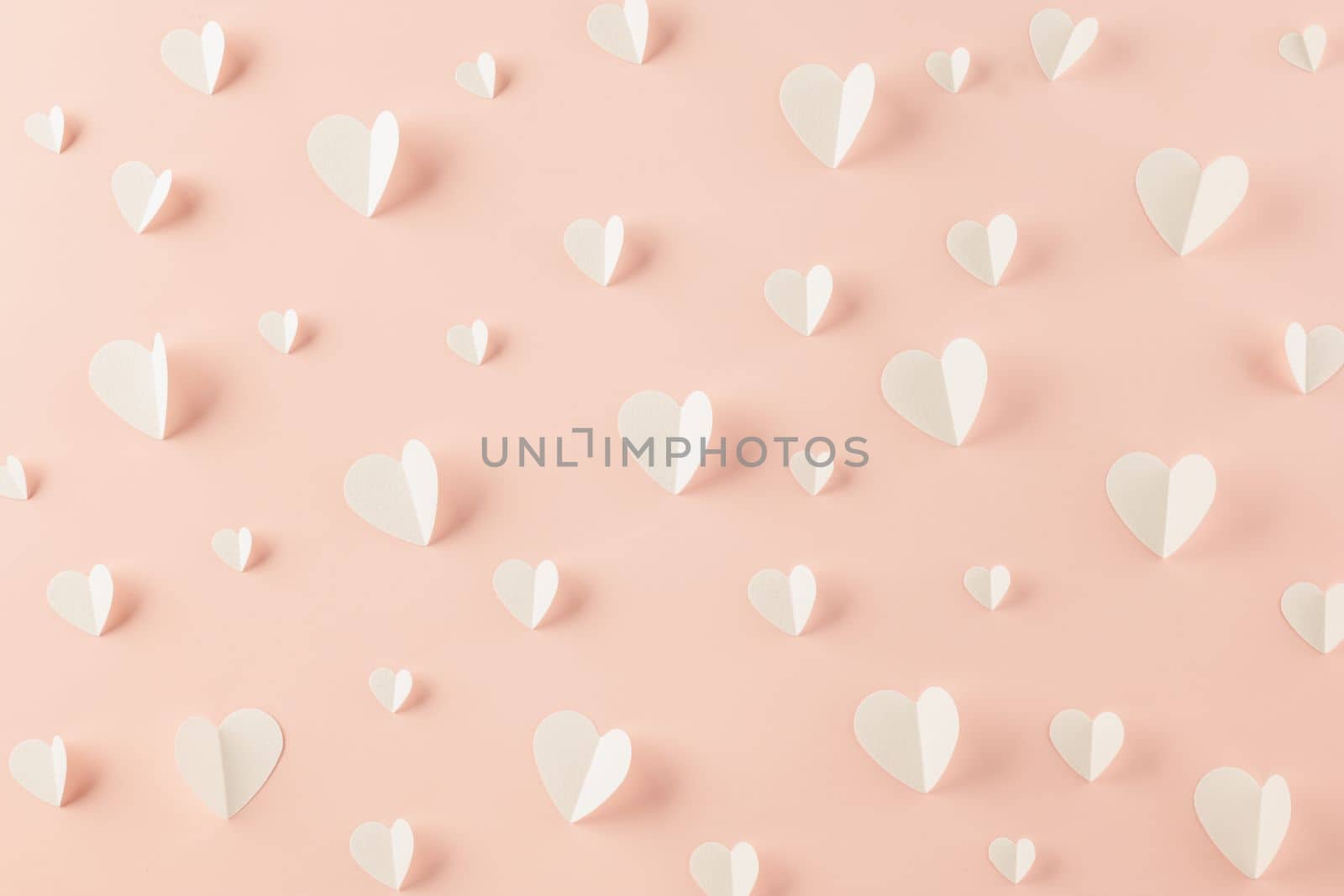 Happy Valentines Day background. Top view flat lay of paper elements cutting white hearts shape flying on pink background, Valentine Love day concept, Banner template design of holiday