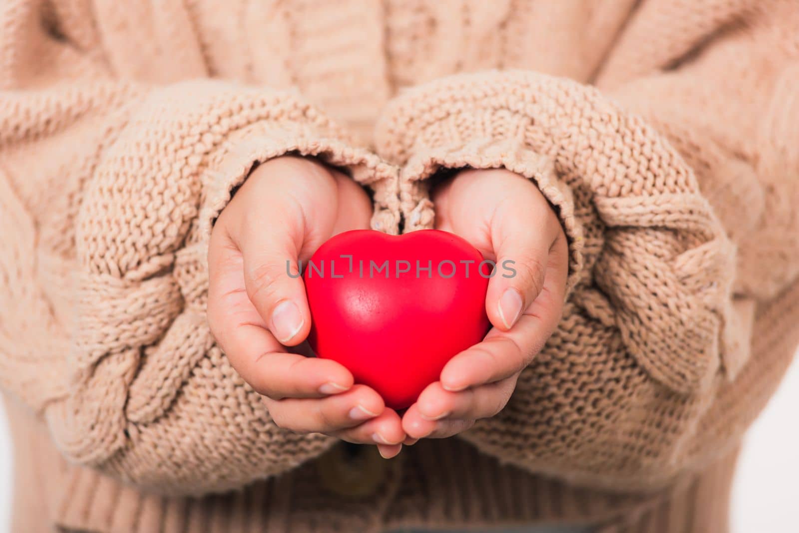 Female beauty hands holding modern a red heart by Sorapop