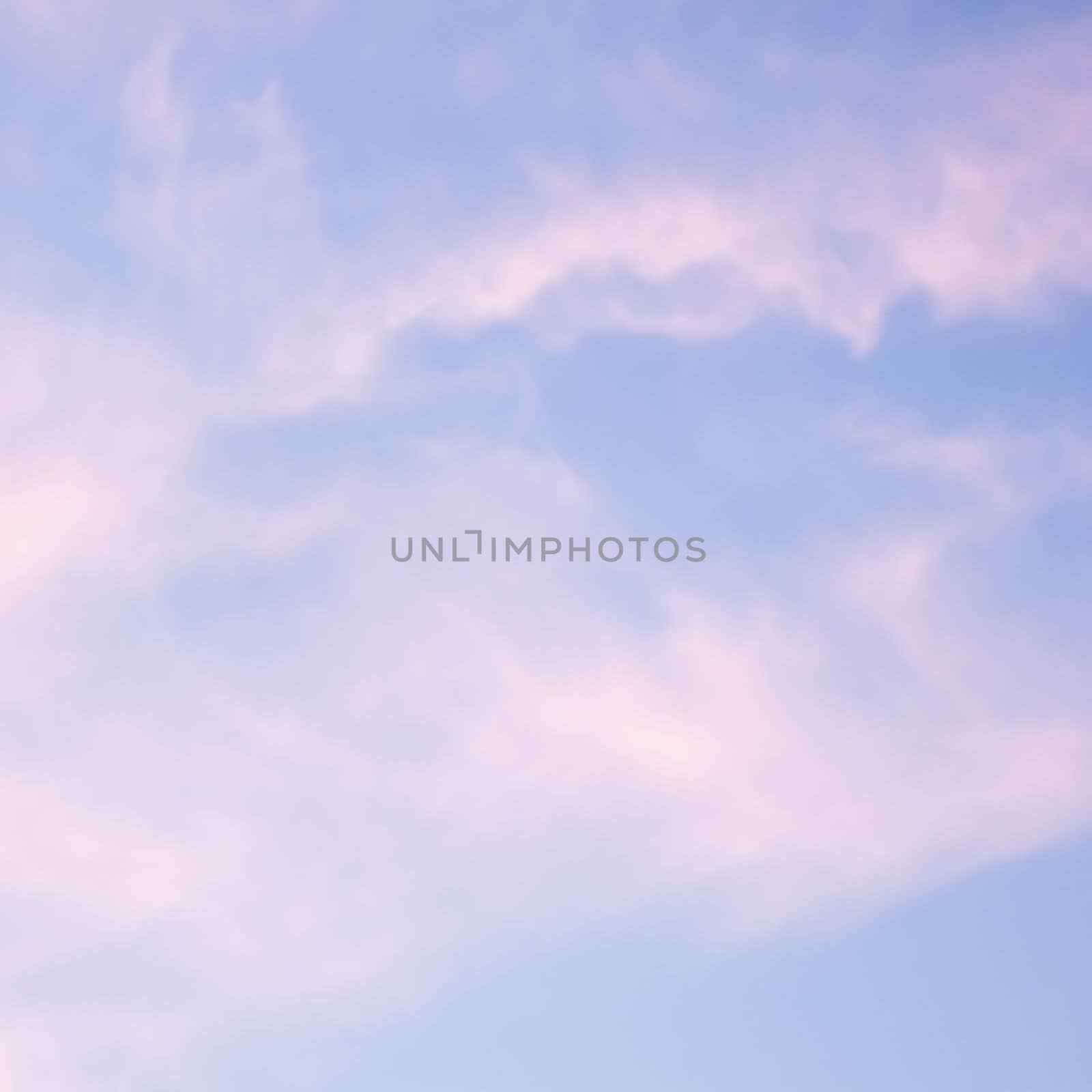 Blue sky background with white and pink clouds at sunset. High quality photo