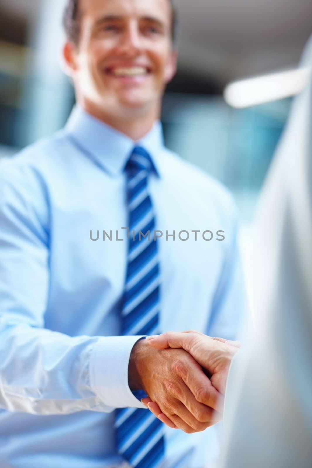 Youve got yourself a deal. two people shaking hands in a corporate environment