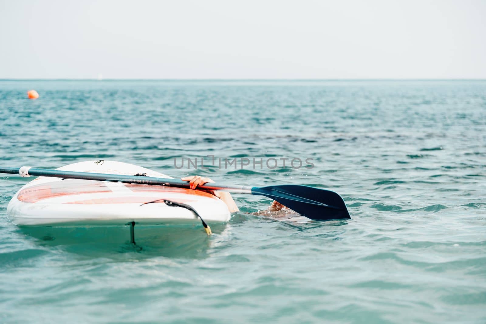 Sea woman sup. Silhouette of happy young woman in pink bikini, surfing on SUP board, confident paddling through water surface. Idyllic sunset. Active lifestyle at sea or river. Slow motion