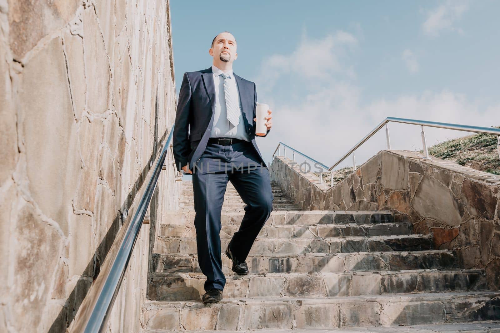 Business executive with briefcase going down the stairs.