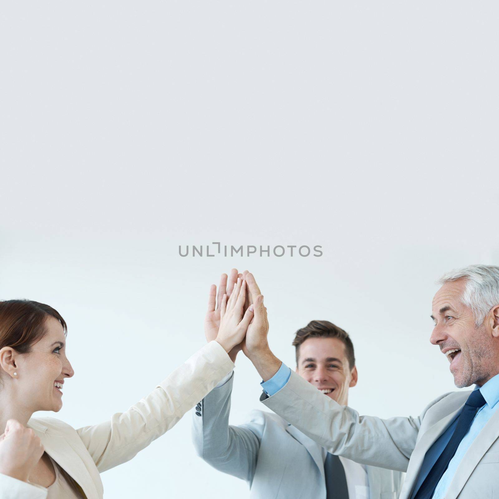 They reached their goals. Business people celebrating another successful deal with a high-five. by YuriArcurs