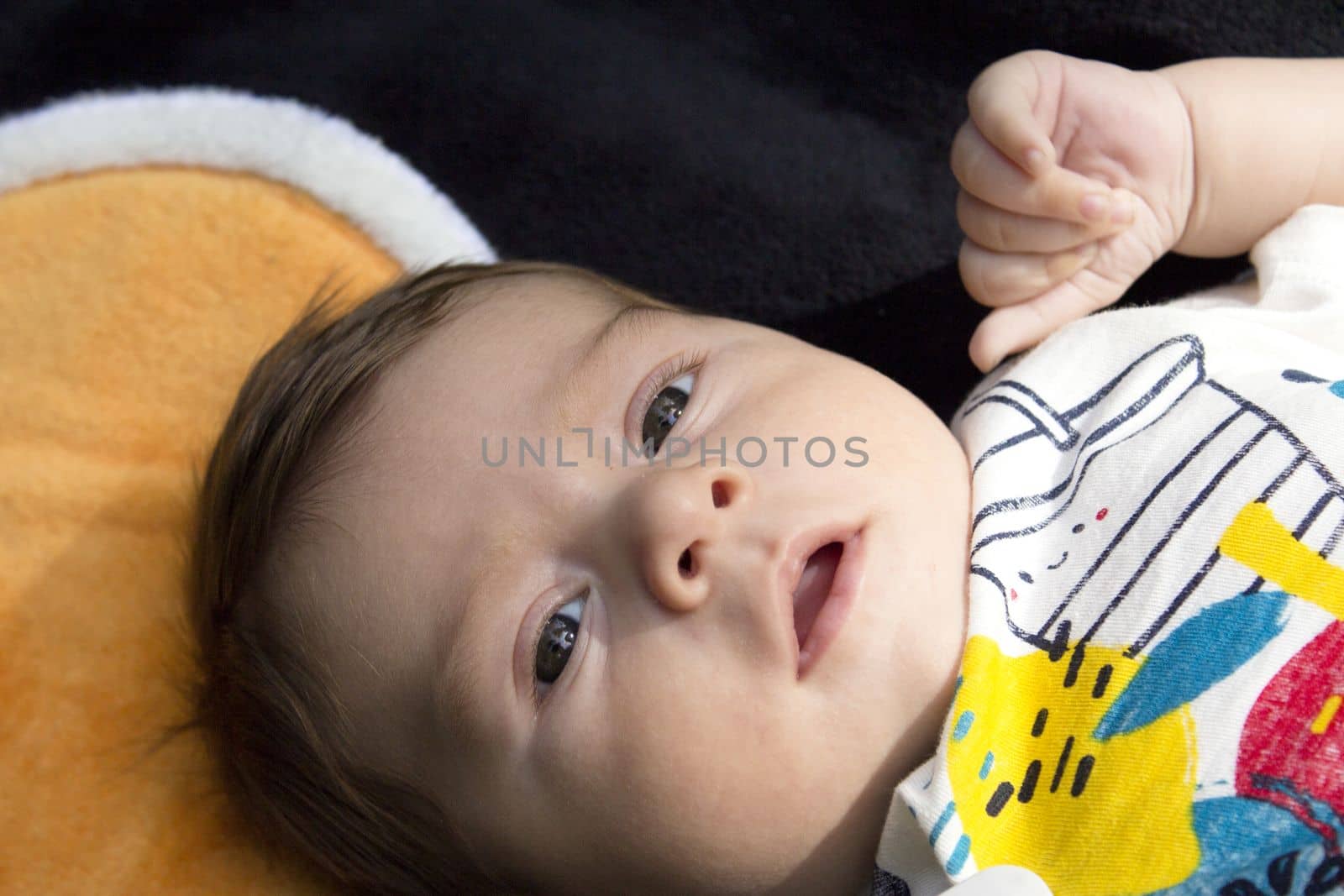 Two month old baby lying on a towel by GemaIbarra