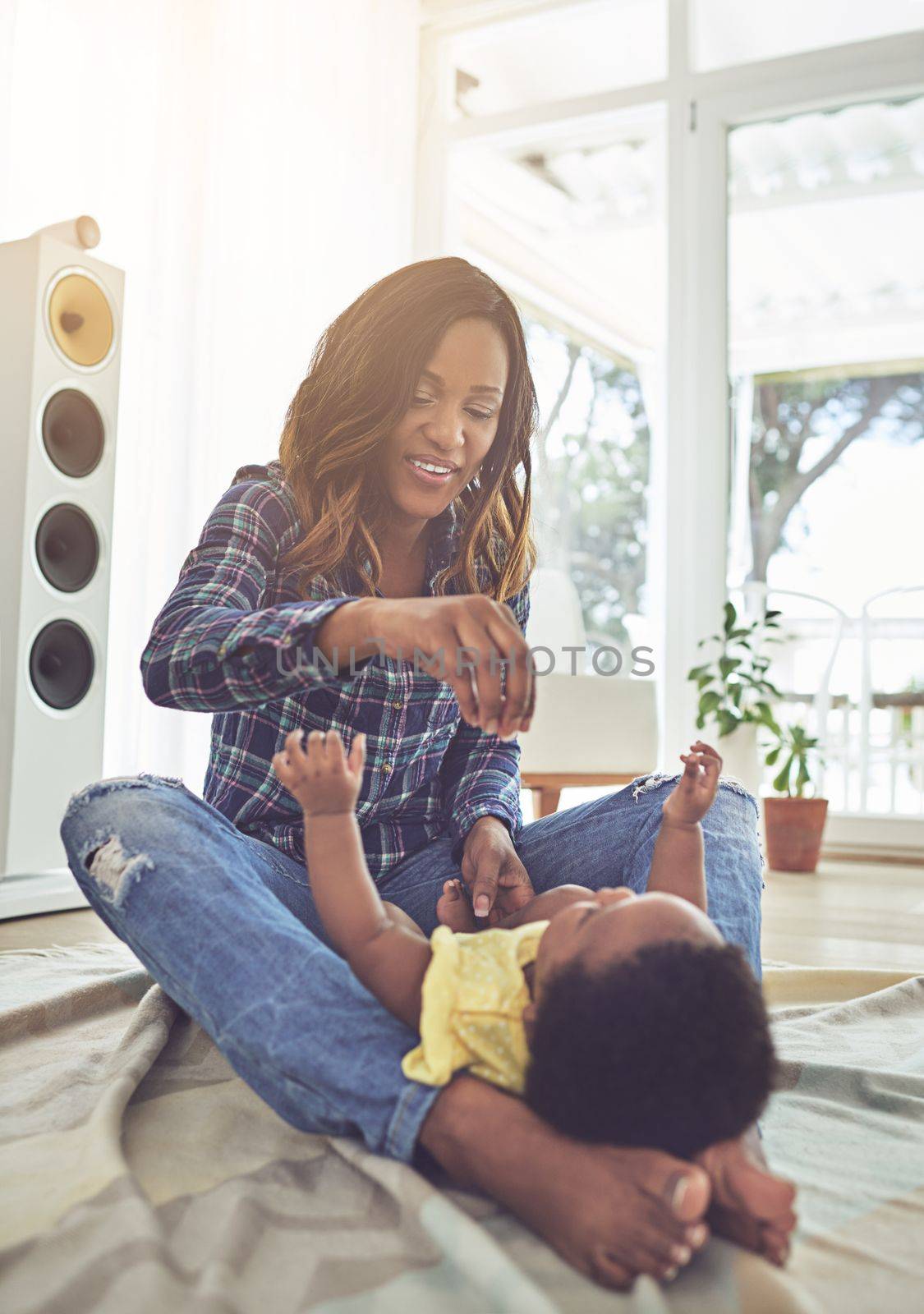 Mommys got your dummy...Full length shot of a young mother and her little baby girl at home. by YuriArcurs