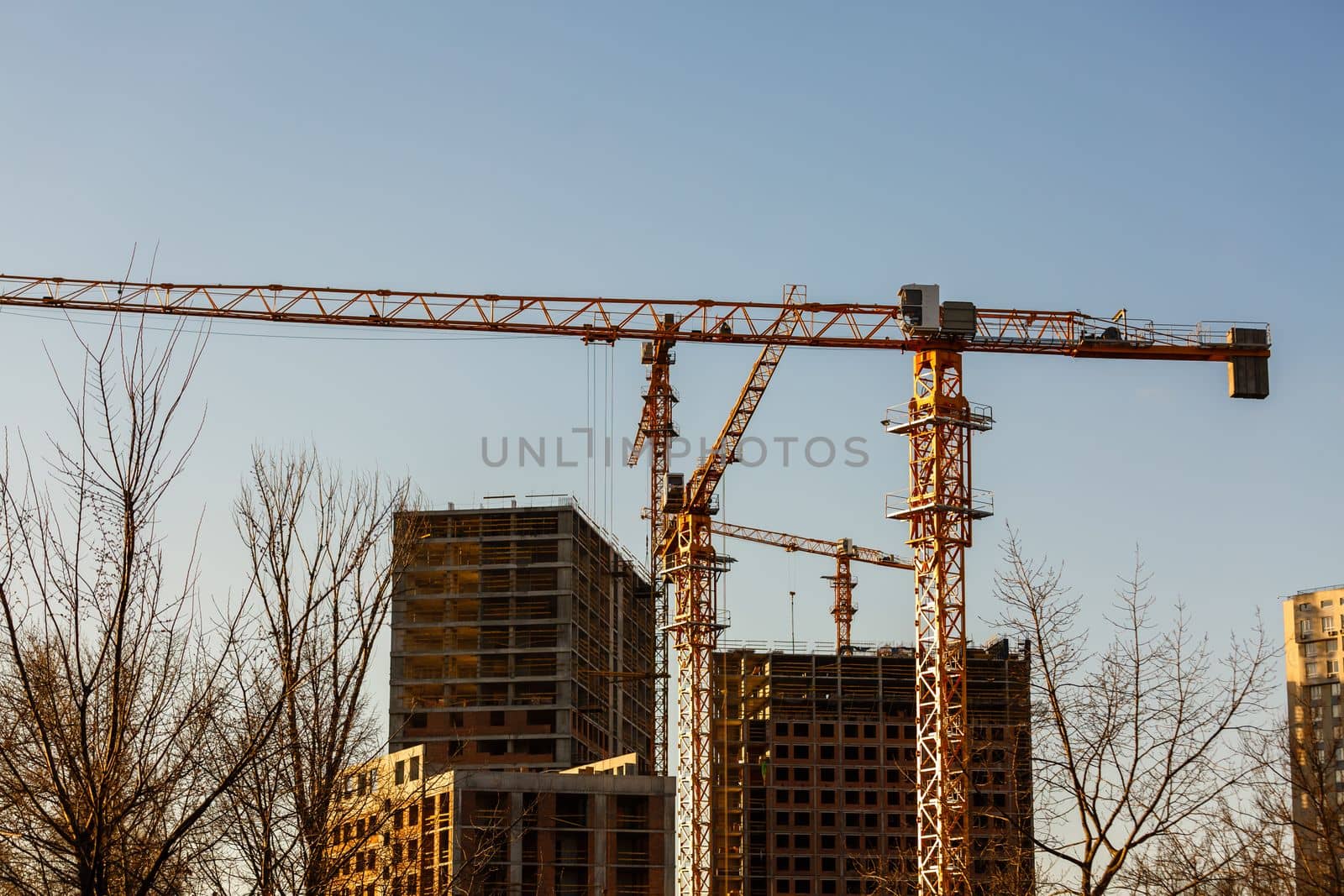 Crane. Construction crane. Building crane on the background of two buildings by Andelov13