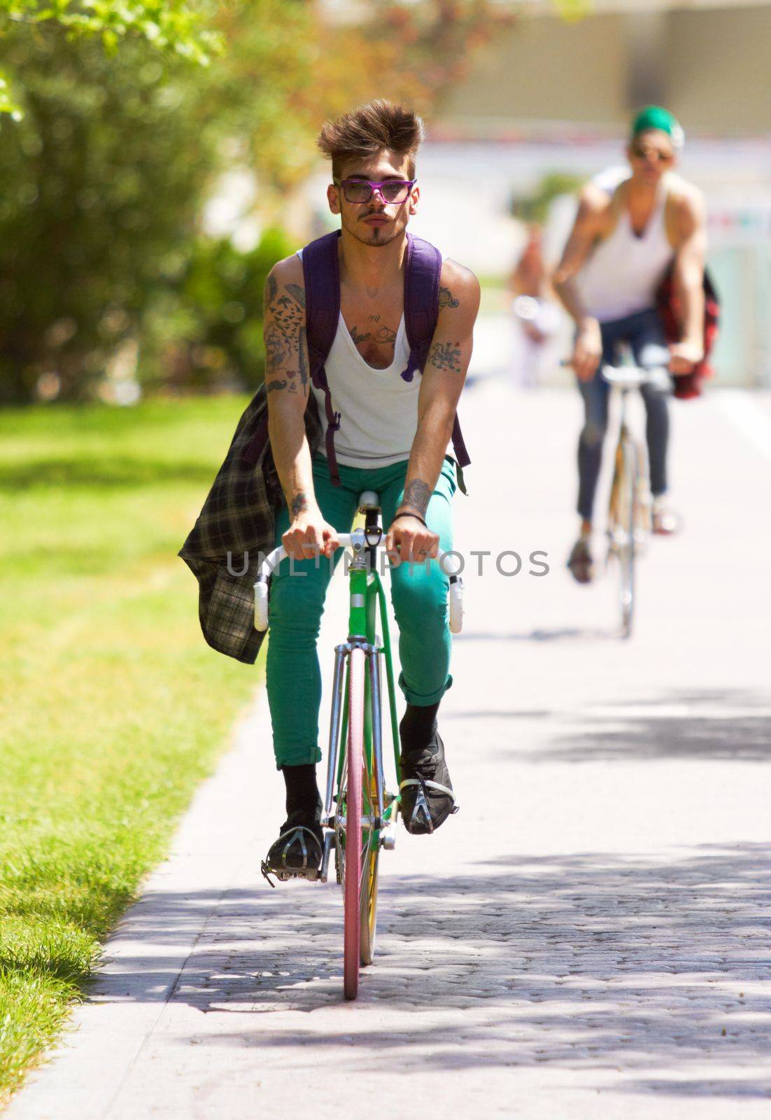 Catch me if you can. Full length shot of two young guys cycling outdoors