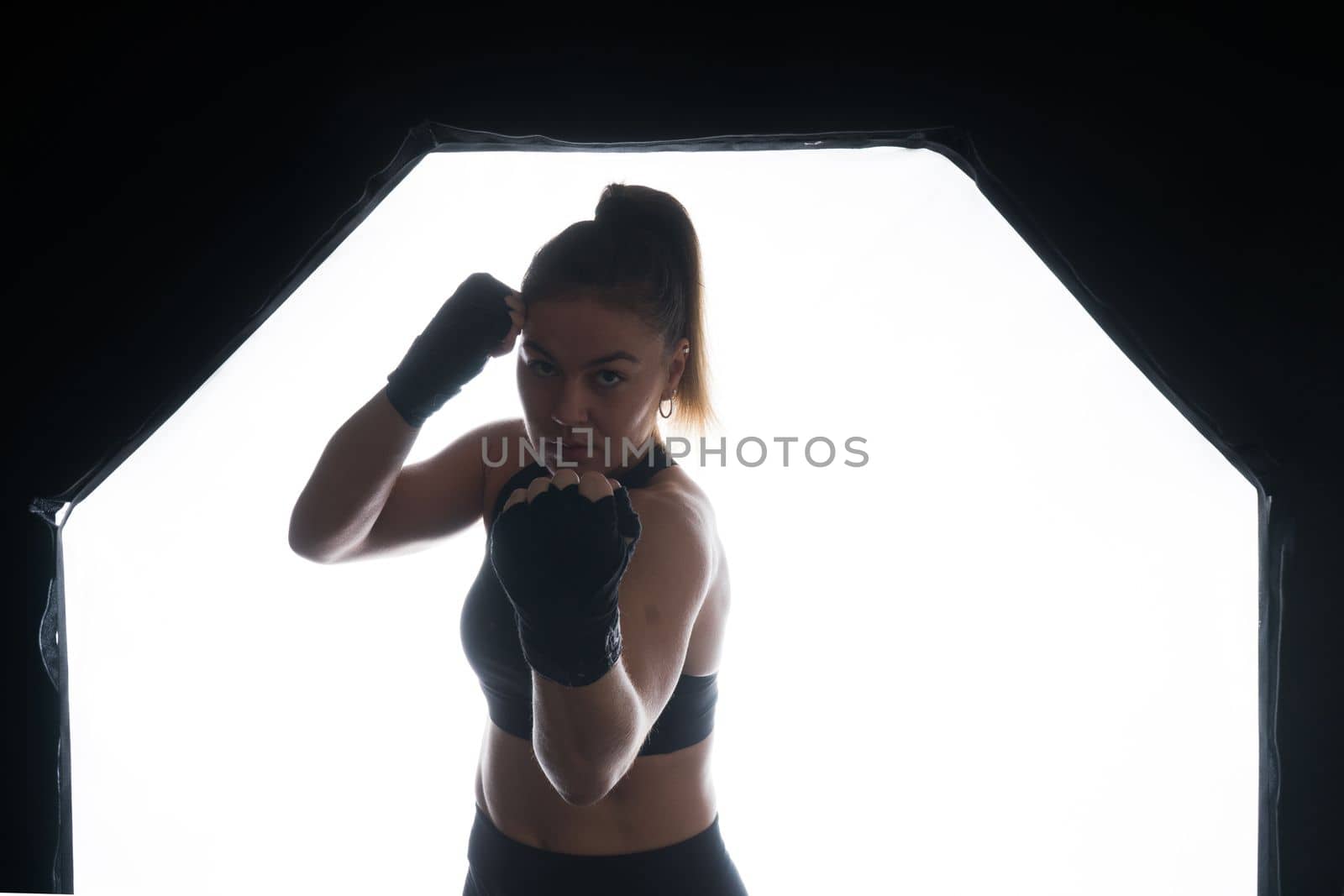 Woman Boxer In Gloves Training On black, red, yellow Background by Zelenin