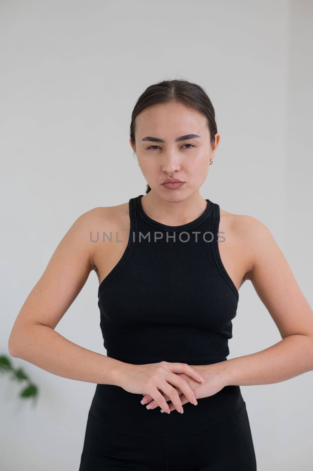 Portrait of a grimacing Asian woman on a white background. by mrwed54