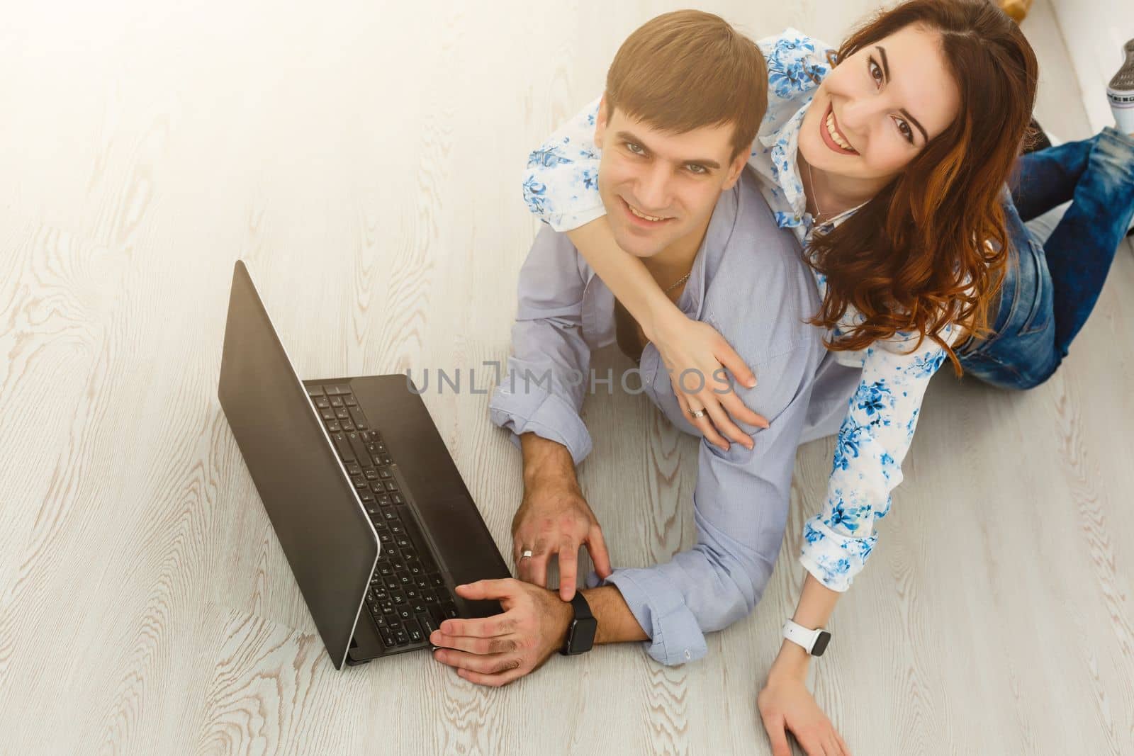 Couple buying online together with a laptop on a desktop at home