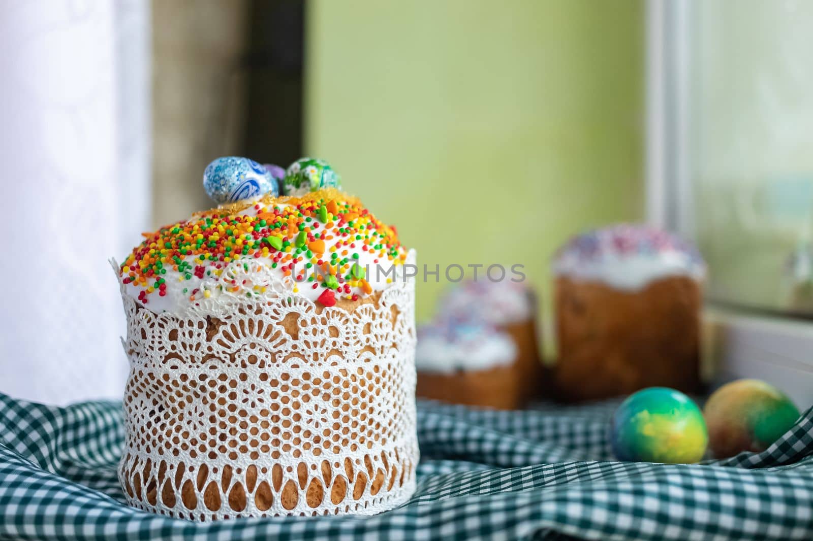 Traditional Easter cake with glace icing and painted easter eggs.Rustic style. Easter arrangement.