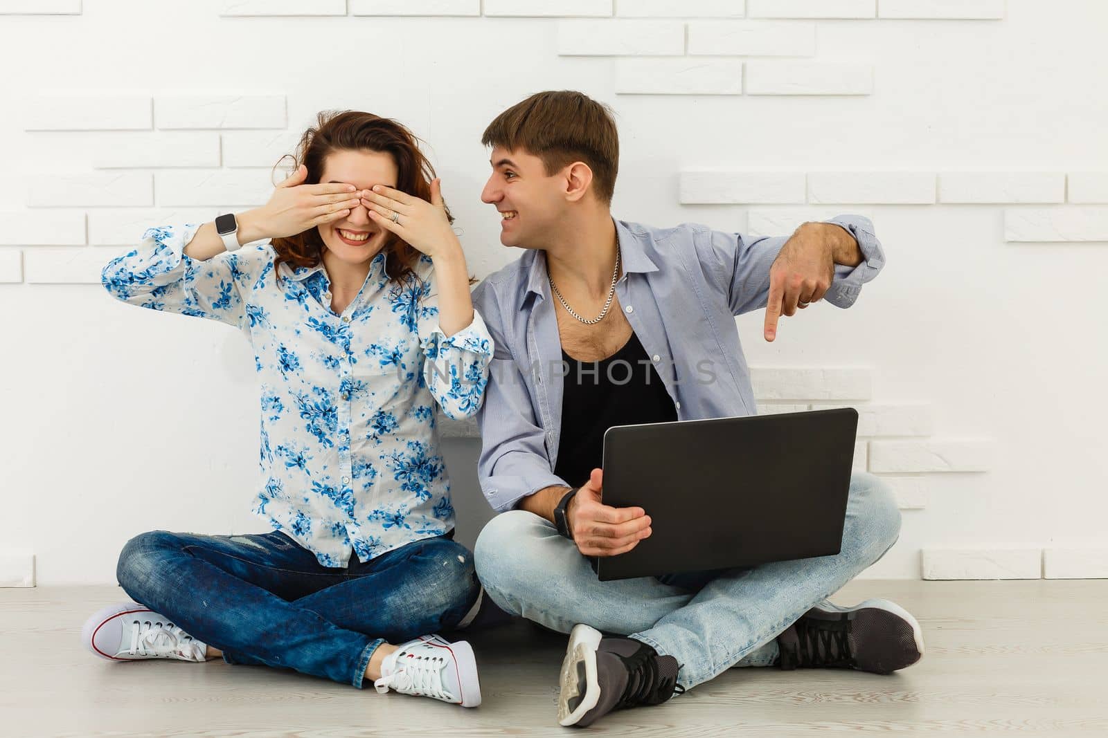Portrait of happy young couple using laptop isolated