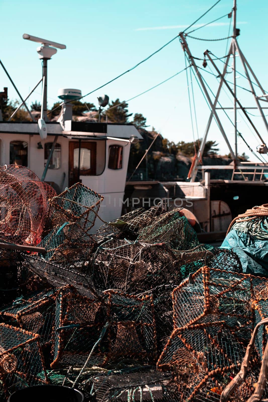 Fishing nets stacked on the pier in a harbour, close-up background fisherman net and boat work