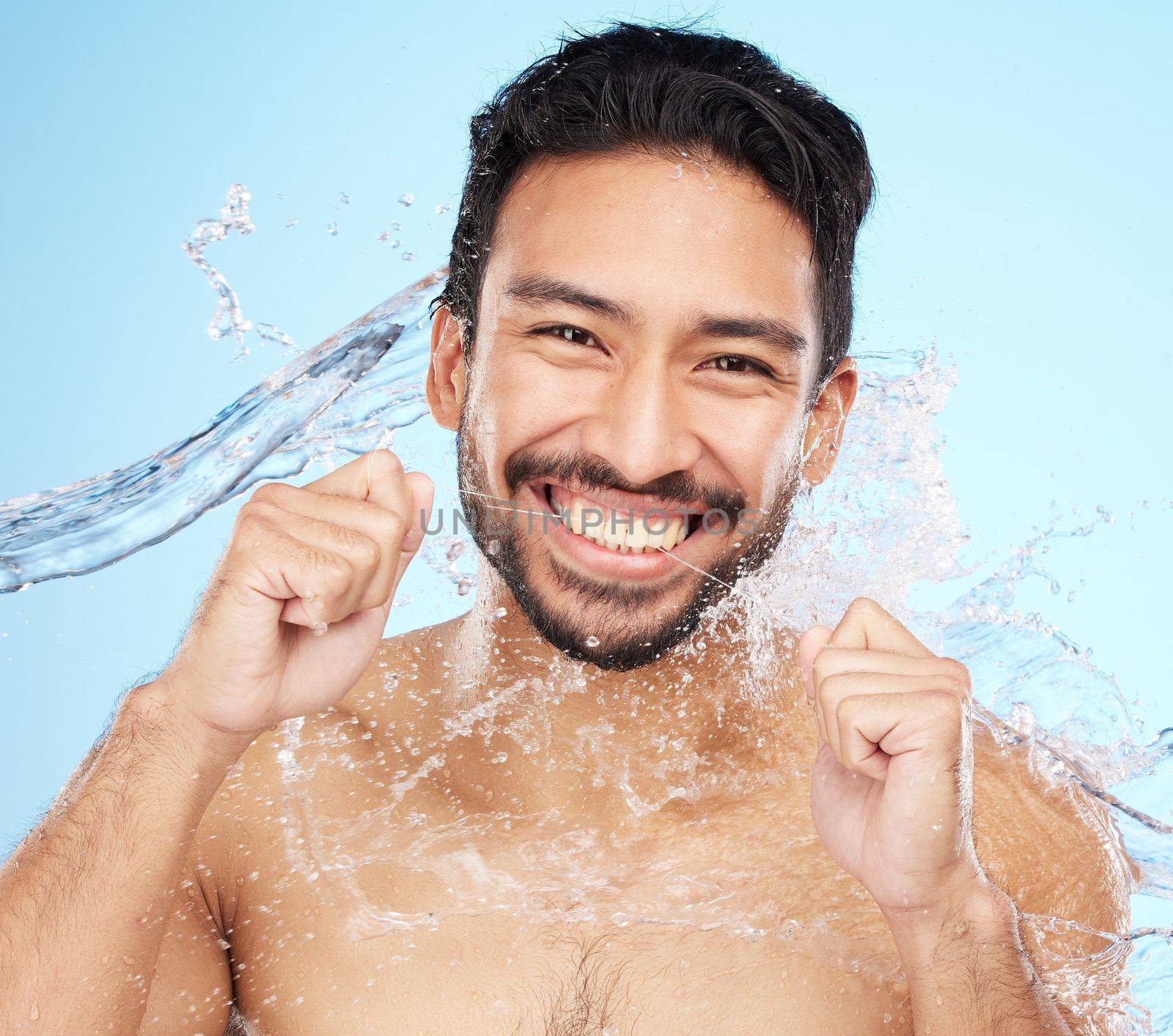 Dental, teeth floss and water splash with man in portrait for hygiene, cleaning and oral healthcare against studio background. Teeth whitening, clean mouth and fresh breath with smile and Invisalign.