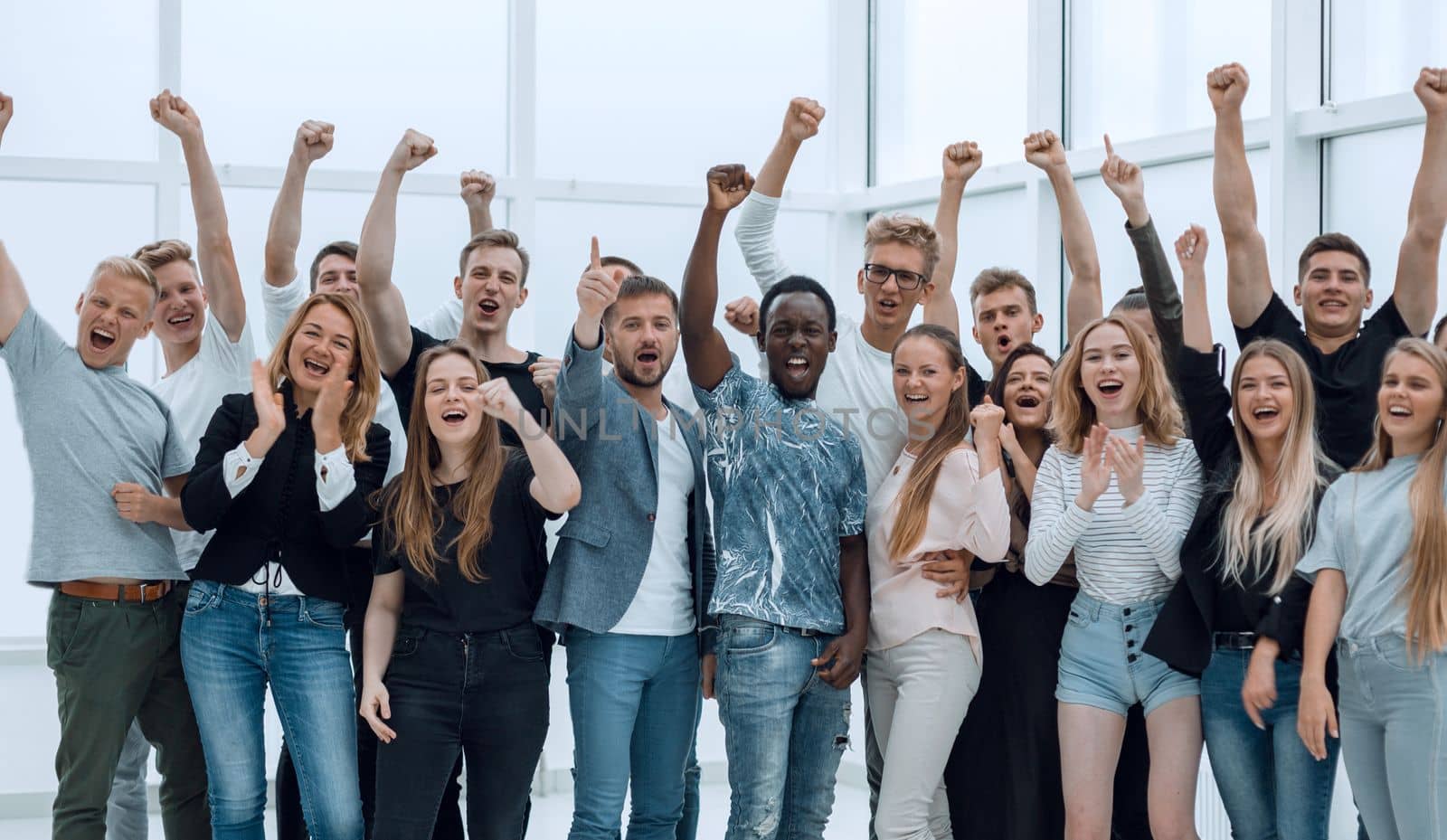 team of happy young people showing their success. photo with copy space