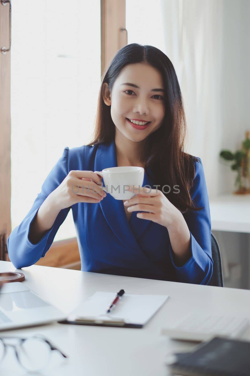 Smiling and happy asian businesswoman looking at camera. Finance and Accounting concept