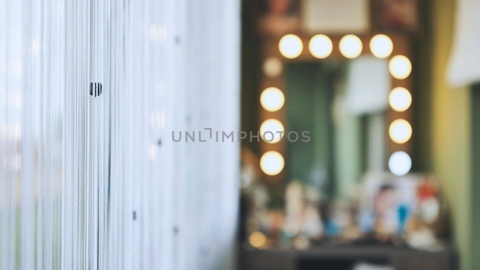 The makeup artist's office against a backdrop of curtains