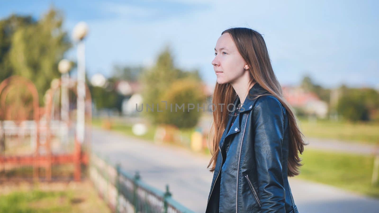 Portrait of a lonely girl by a lake