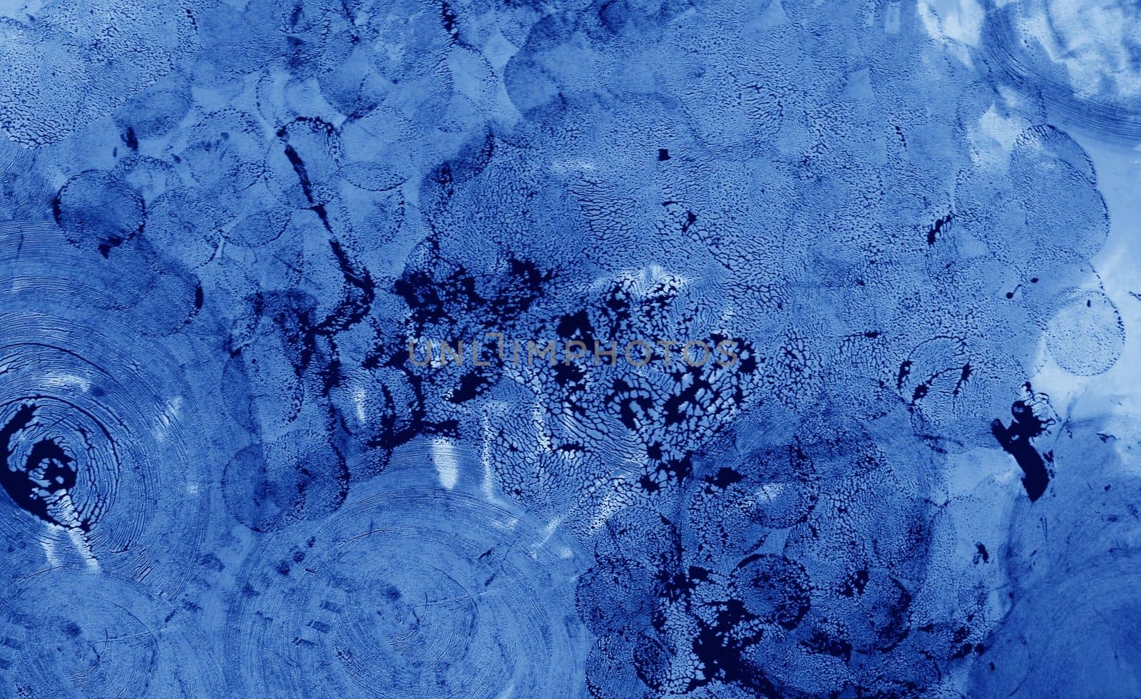 A pattern of dried paint on the surface. Round spots of blue paint on the wall.