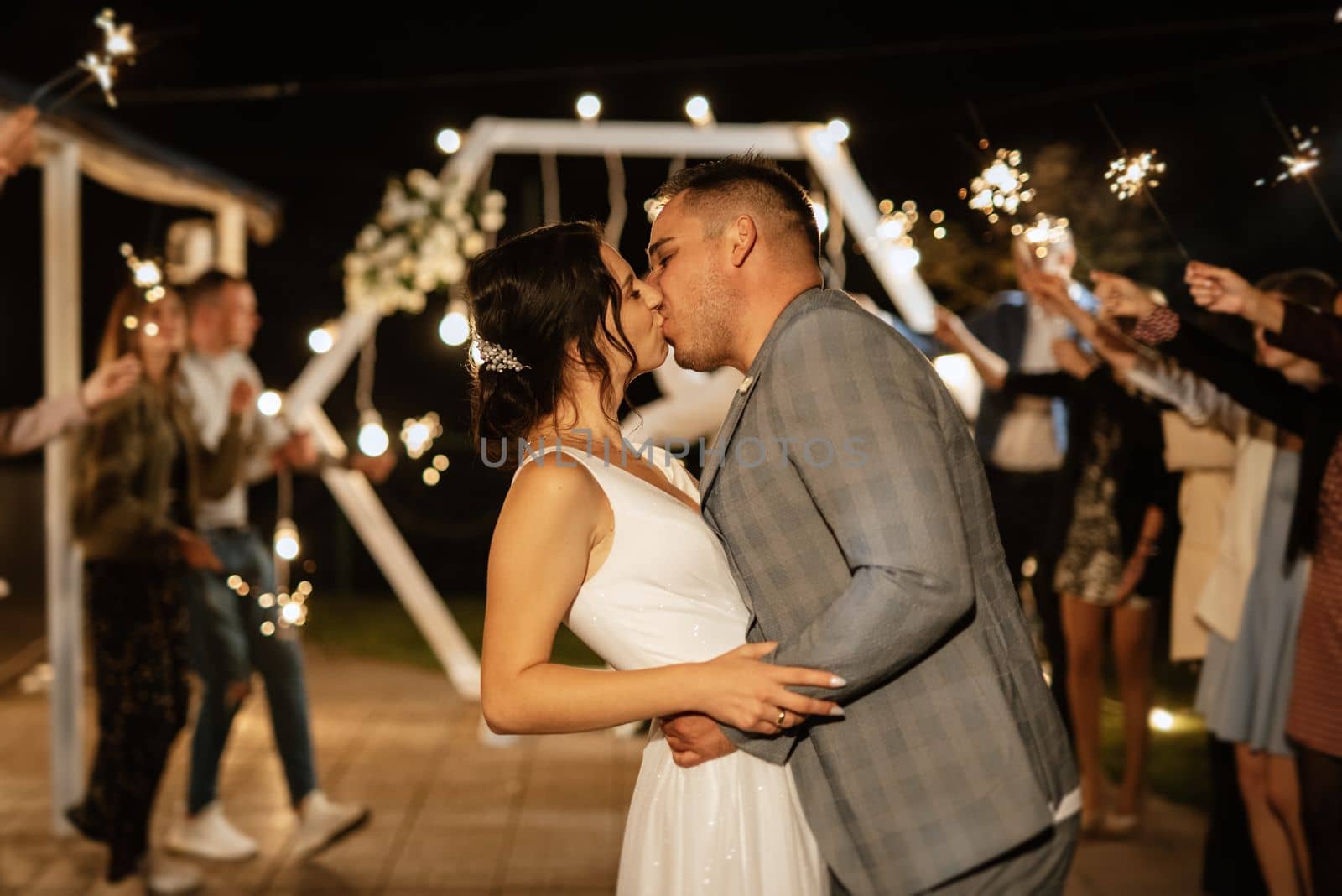 newlyweds at a wedding in the corridor of sparklers