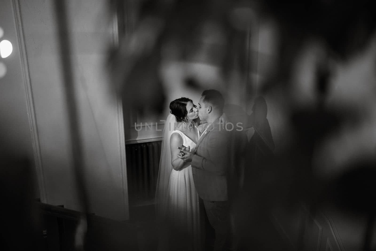 young couple the groom in a blue suit and the bride in a white dress on a walk