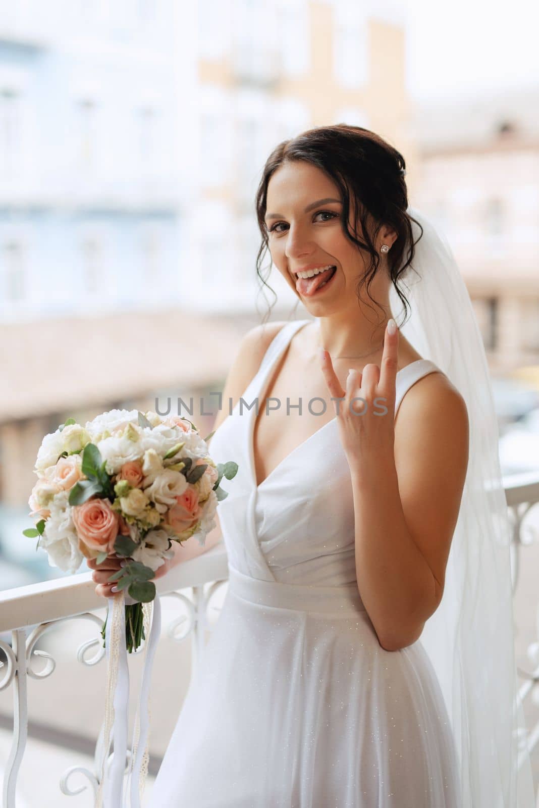 preparations for the bride with the dressing of the wedding dress in the studio