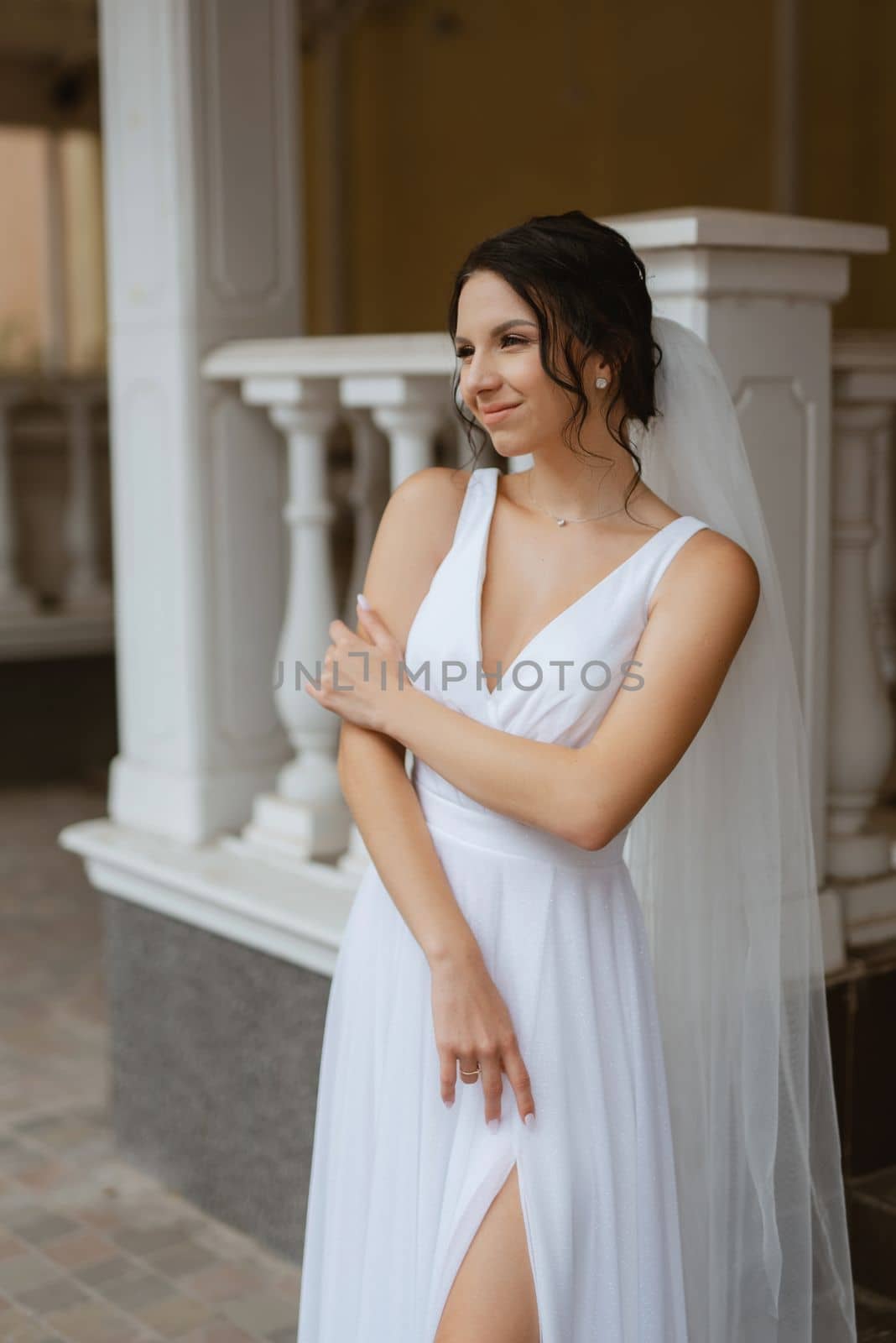 preparations for the bride with the dressing of the wedding dress in the studio