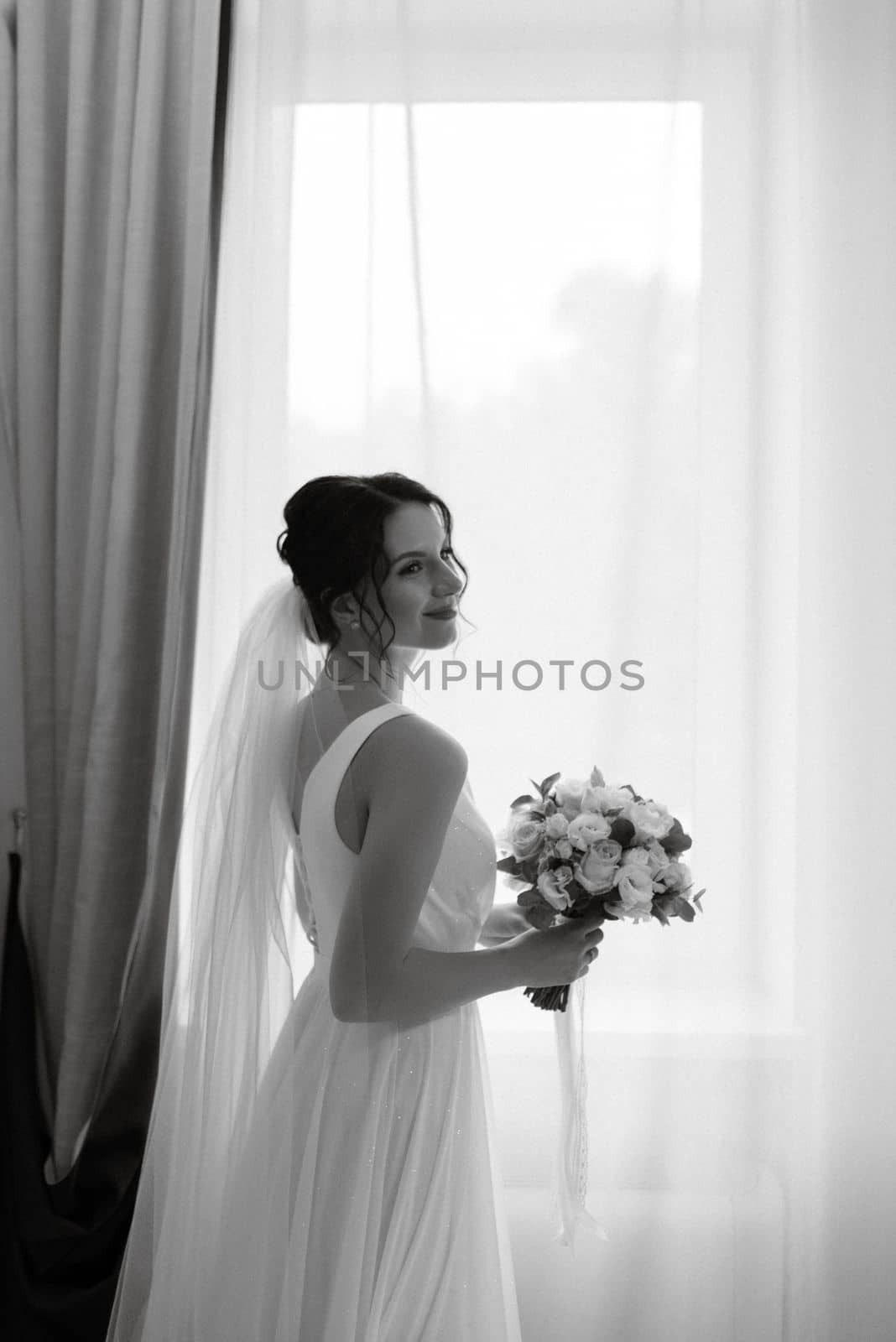 preparations for the bride with the dressing of the wedding dress in the studio