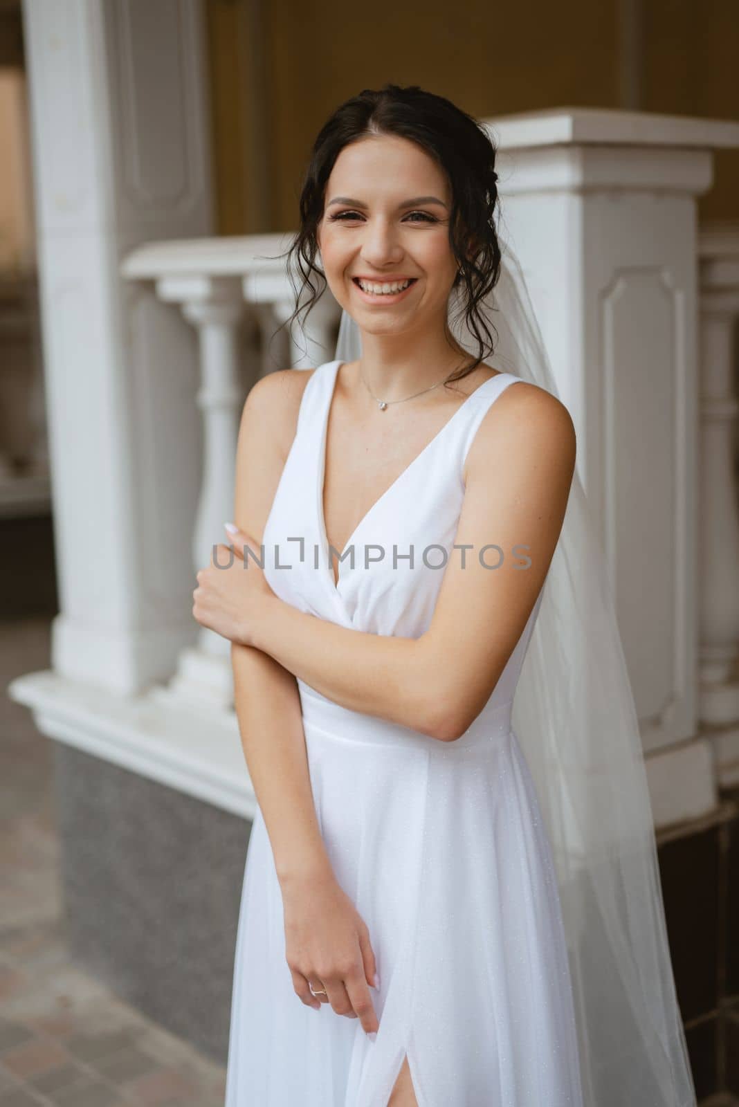 preparations for the bride with the dressing of the wedding dress in the studio