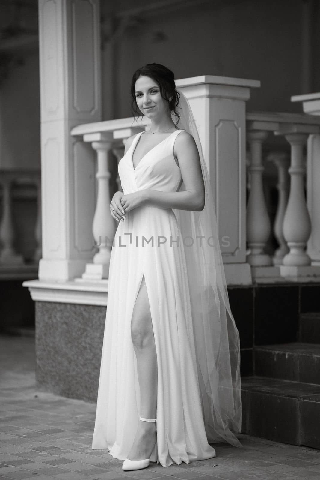 preparations for the bride with the dressing of the wedding dress in the studio