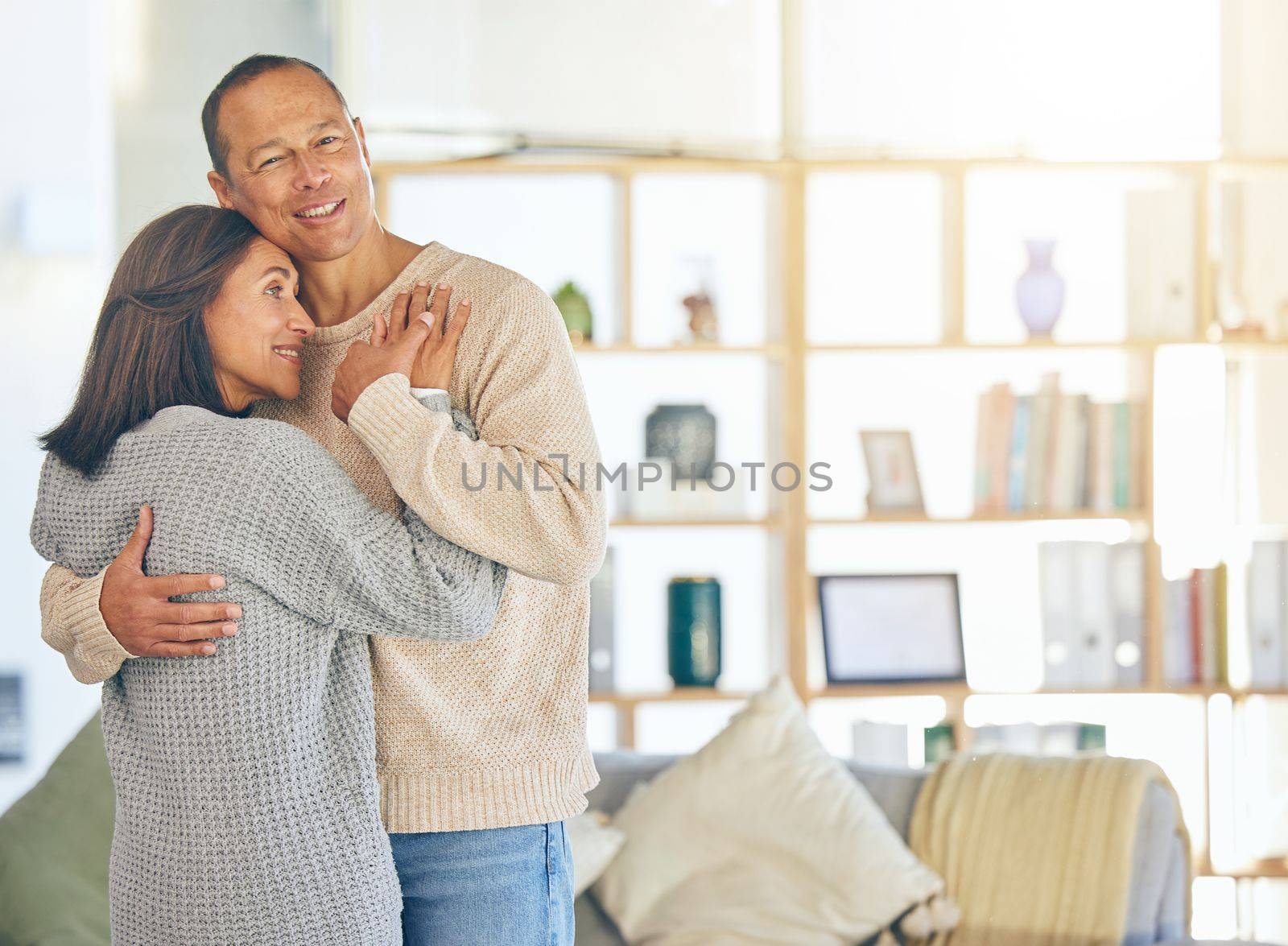 Love, romance and married with a couple hugging while standing in their home together with mockup or flare. Affection, bonding and hug with a mature man and woman embracing in their domestic house.