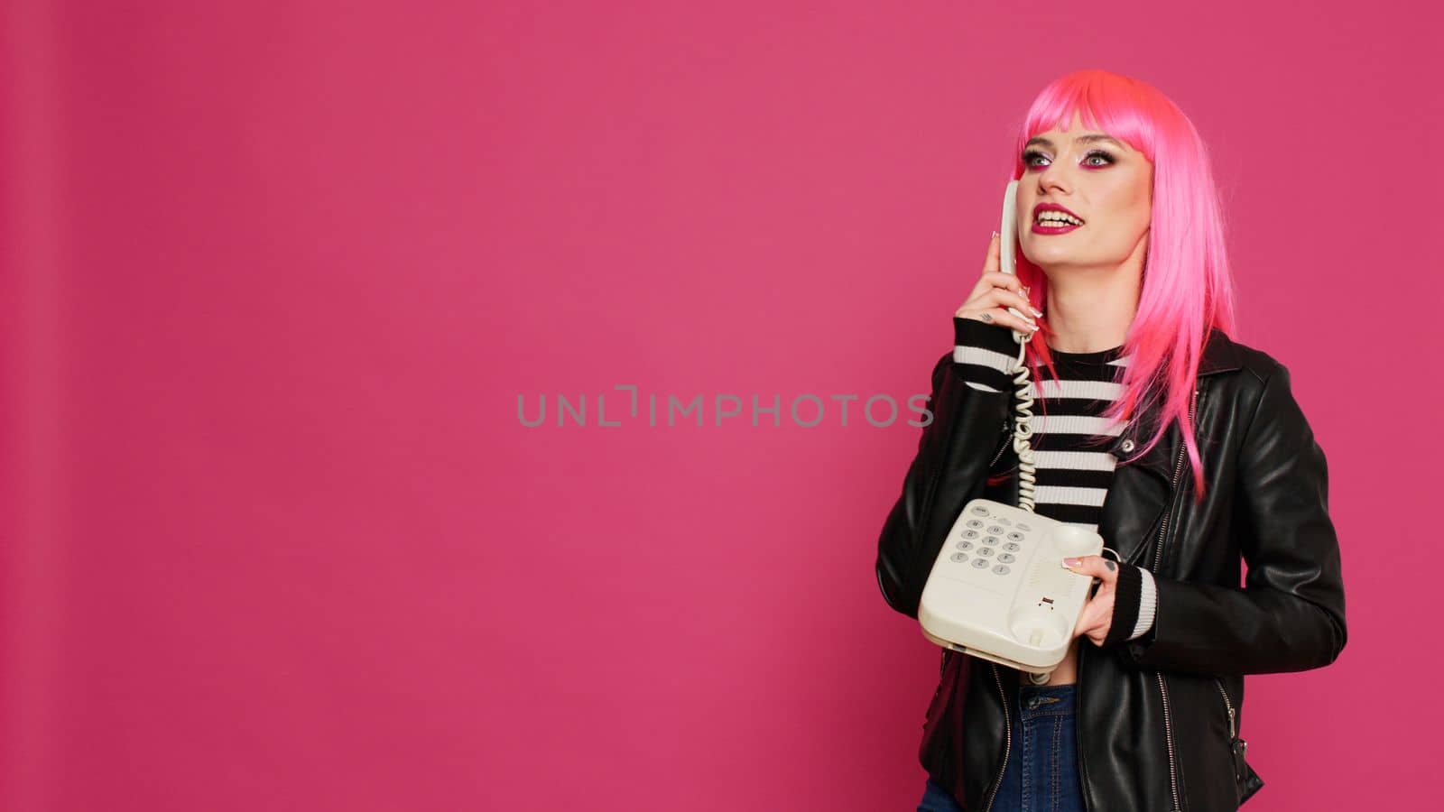 Young stylish person chatting on vintage telephone line by DCStudio