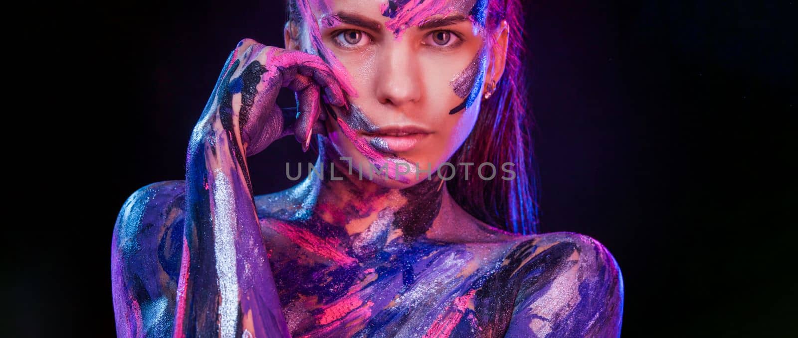 Woman in neon lights. Portrait of dancer at club party. Body art with bodypaint. Download cover for art book. by MikeOrlov