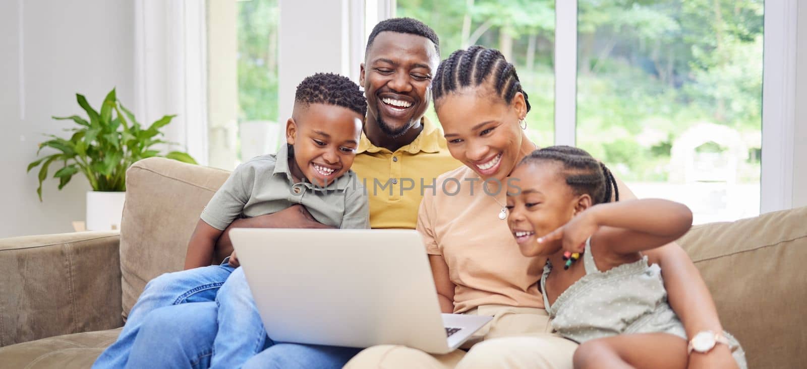 I saw the shorts for this. a young family sitting on the sofa together at home and using a laptop