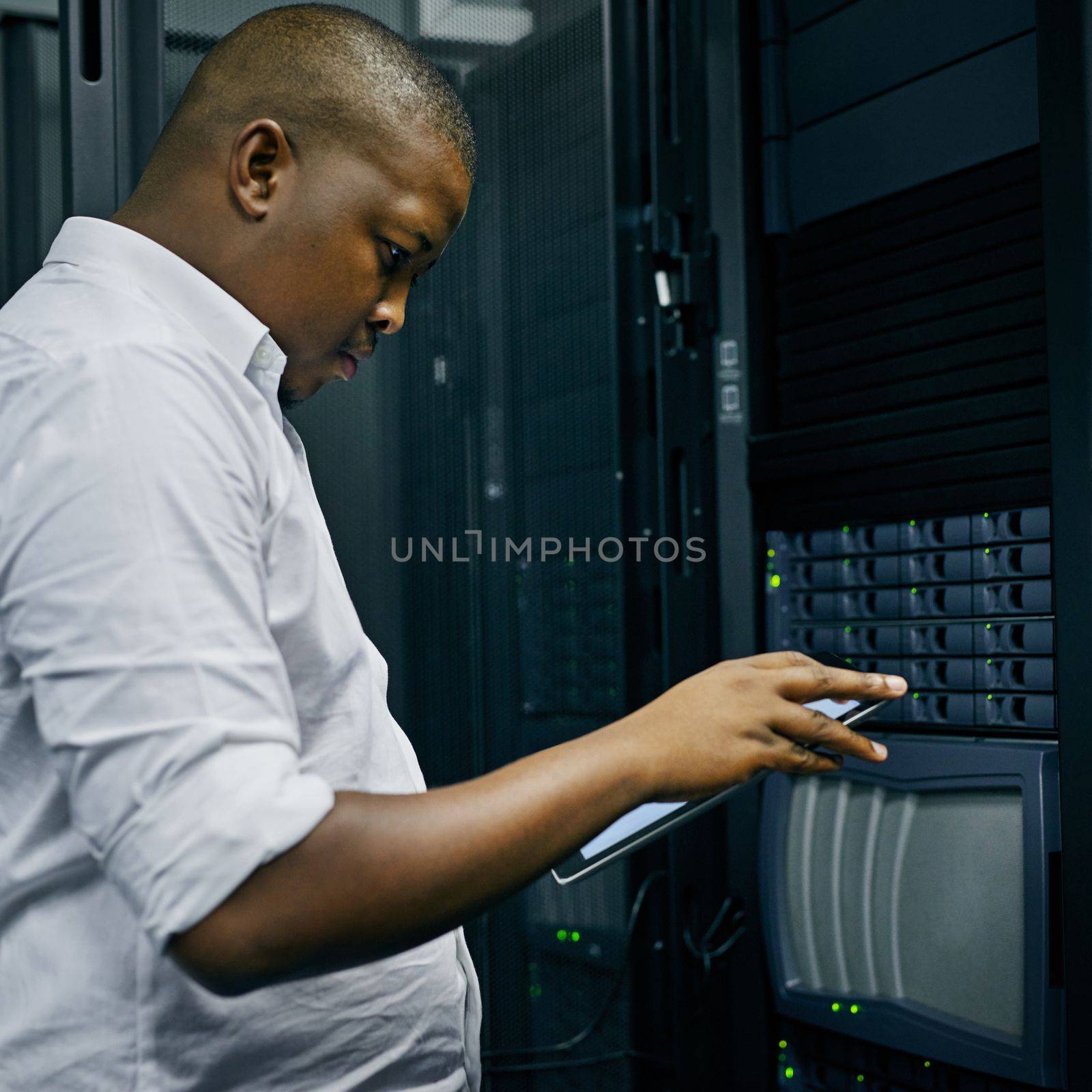 Smart technology for smart system administration. an IT technician using a digital tablet while working in a data center