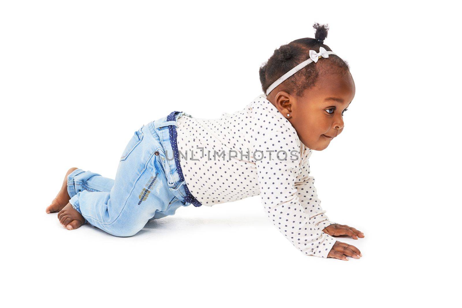 Just keep moving. Studio shot of a baby girl crawling against a white background