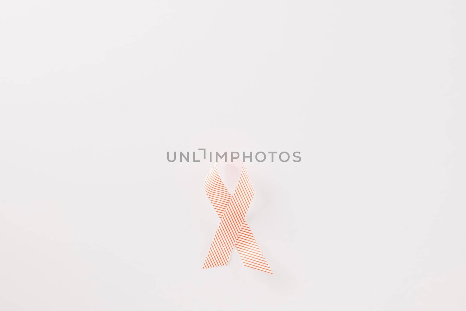 Close up pink awareness ribbon of International World Cancer Day by Sorapop
