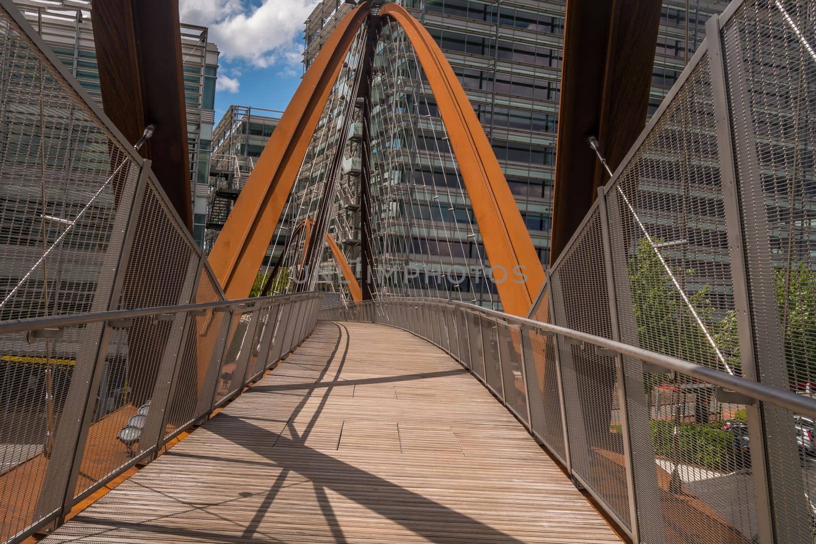 London 7 Jun 62 - A bridge towards a modern looking building. building and the bridge which are situated in a business park.