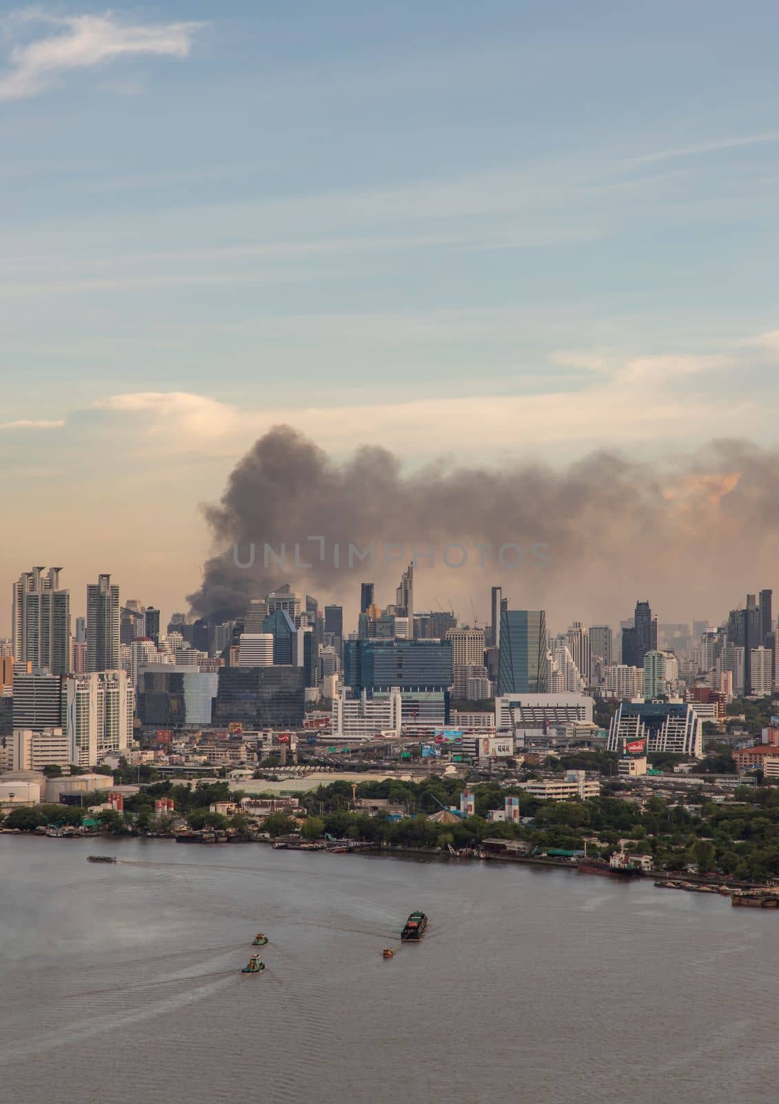 Bangkok, Thailand - Jun 23, 2020 : Aerial photograph of a group of black smoke rising from a fire on a tall building in Bangkok.