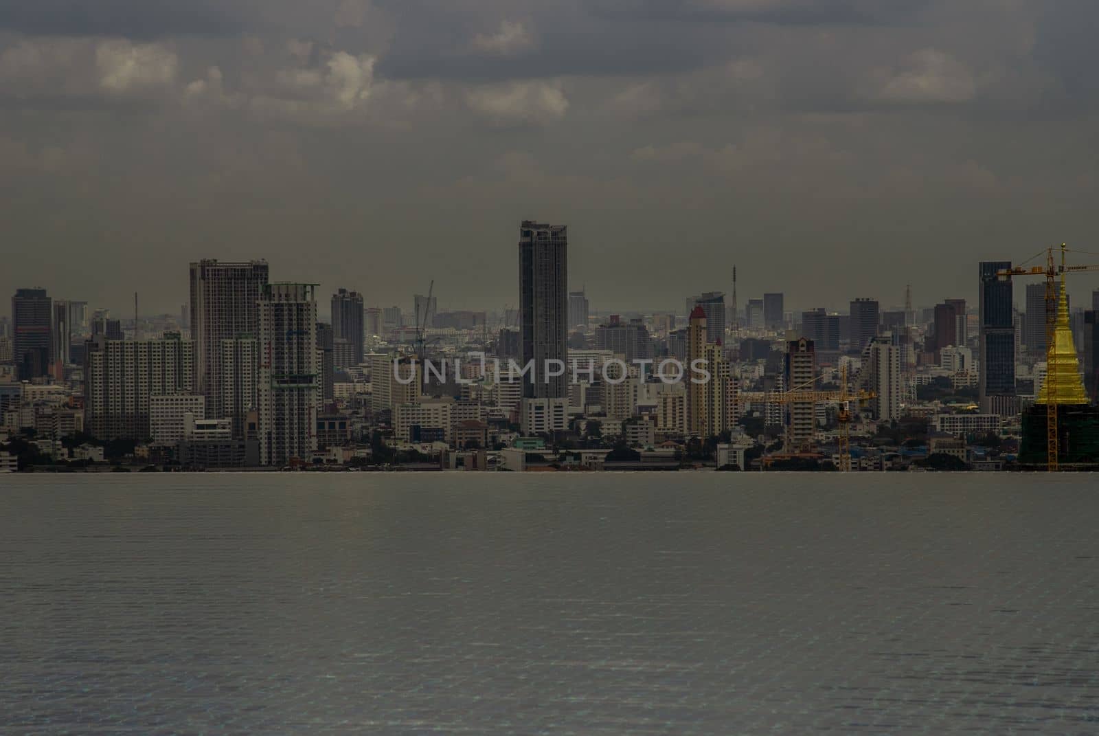 Bangkok, Thailand - Oct 05, 2019 : Beautiful view of city at afternoon Look through the roof top infinity pool in Bangkok.