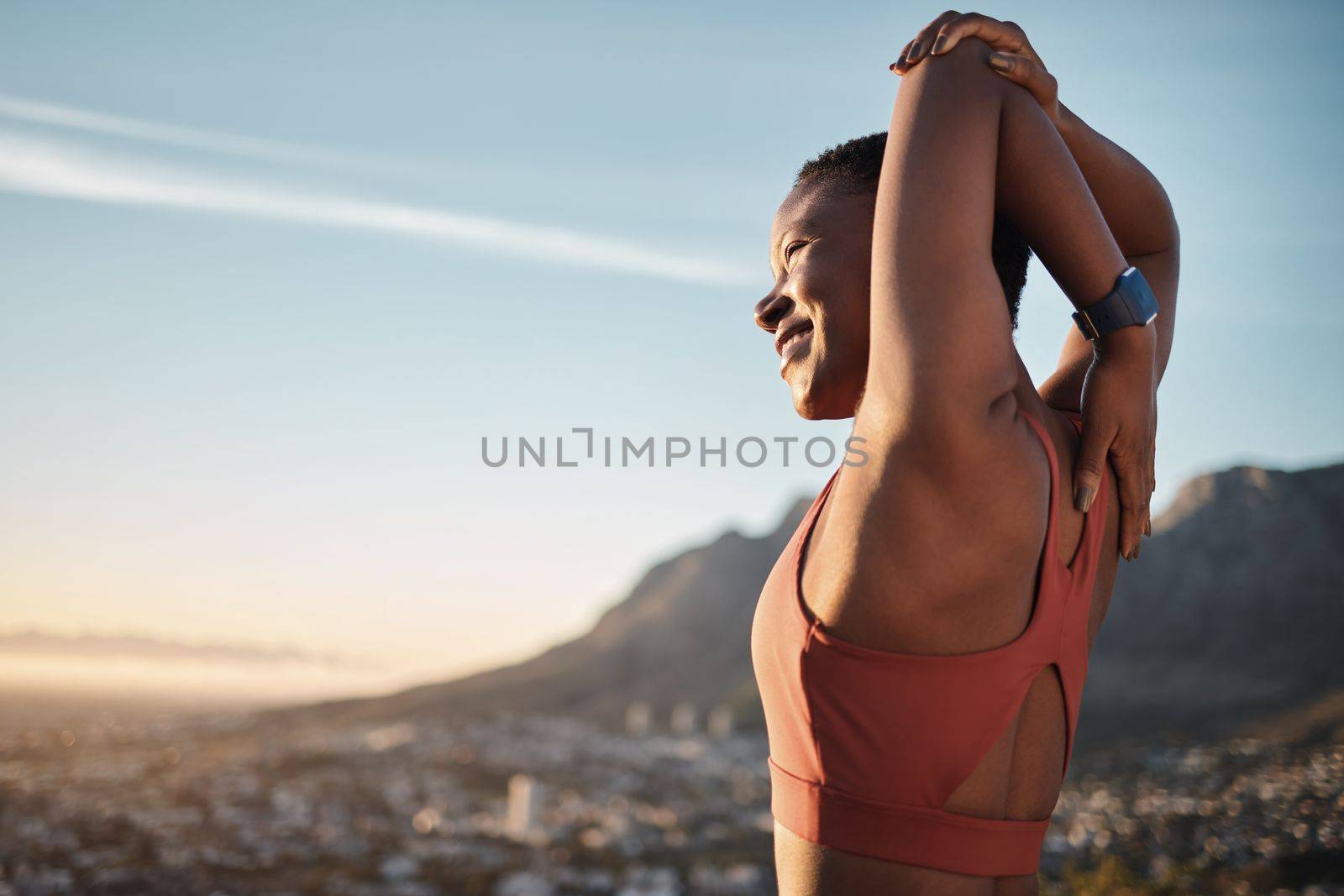Mountain, fitness and stretching woman with smile for running goals, success or training freedom on blue sky mockup. Muscle wellness of sports black woman or runner in nature for workout and exercise.